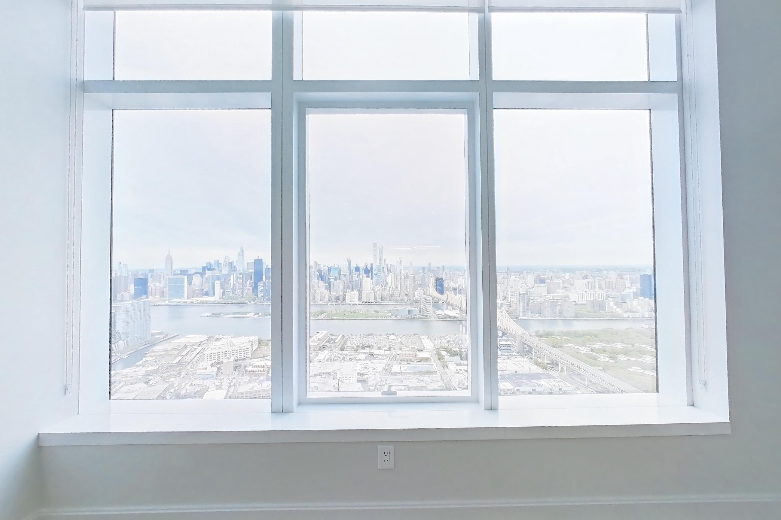 Living room with city view, dark wood-finish flooring, and water view, Apartment PH1H at Lumen
