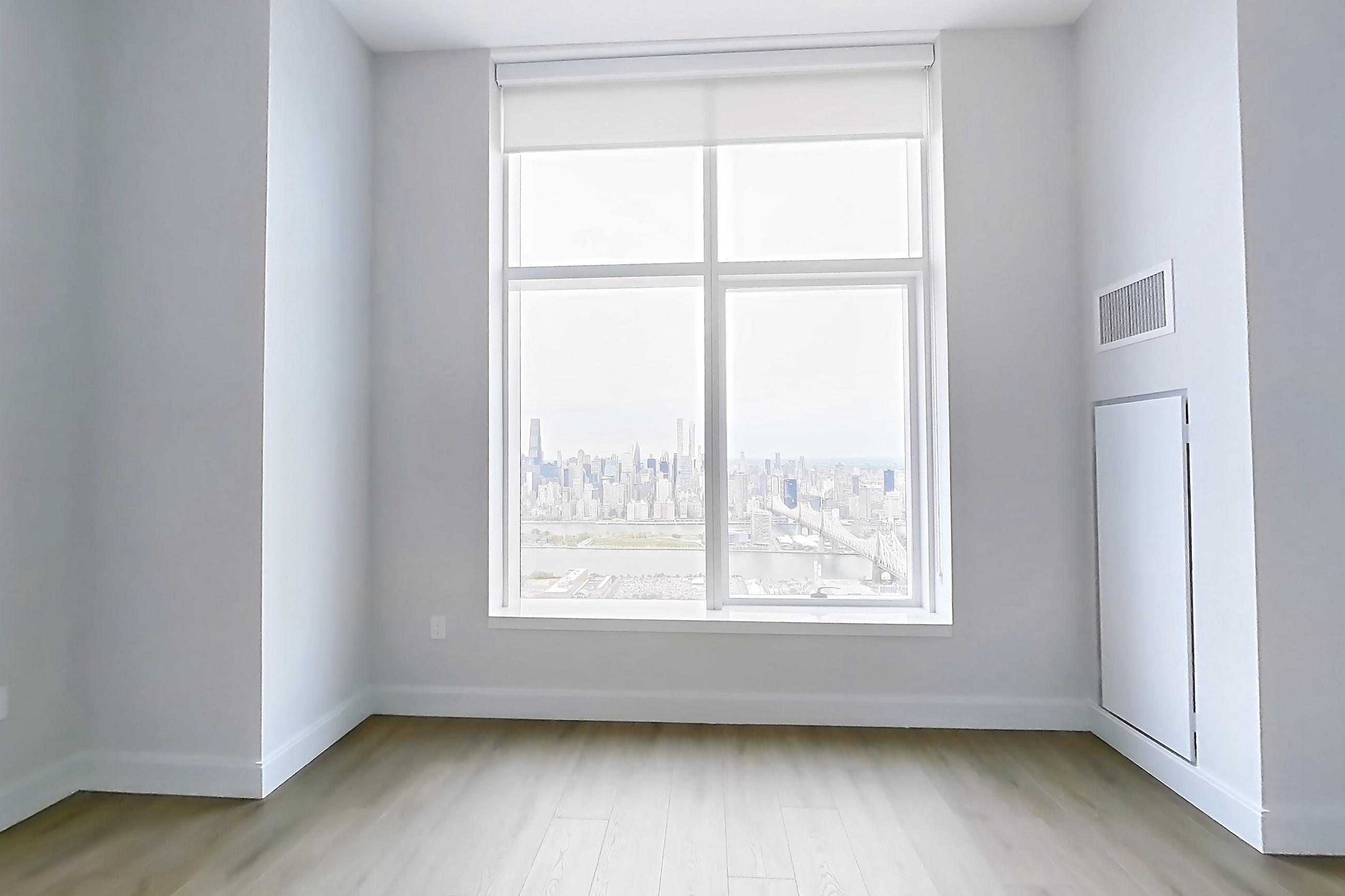 Living space with city view, light wood-finish flooring, and water view, Apartment PH1L at Lumen