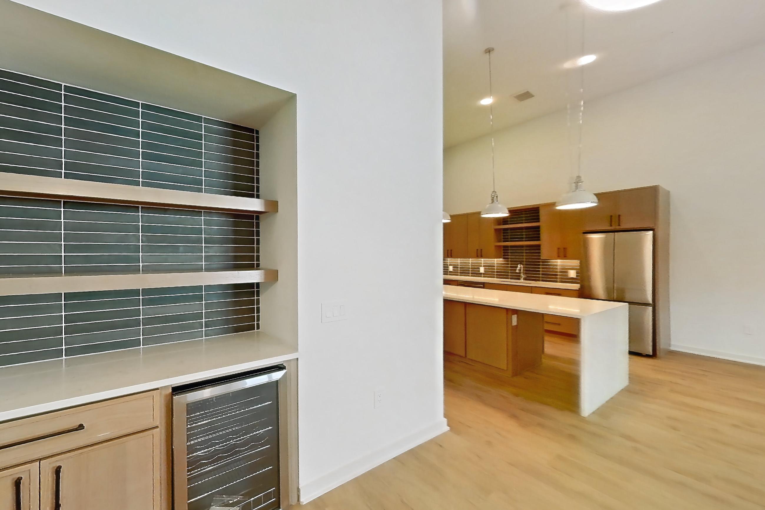 Dining room with light wood-finish flooring, refrigerator, and stainless steel appliances, Apartment 1109 at Cortland Galleria