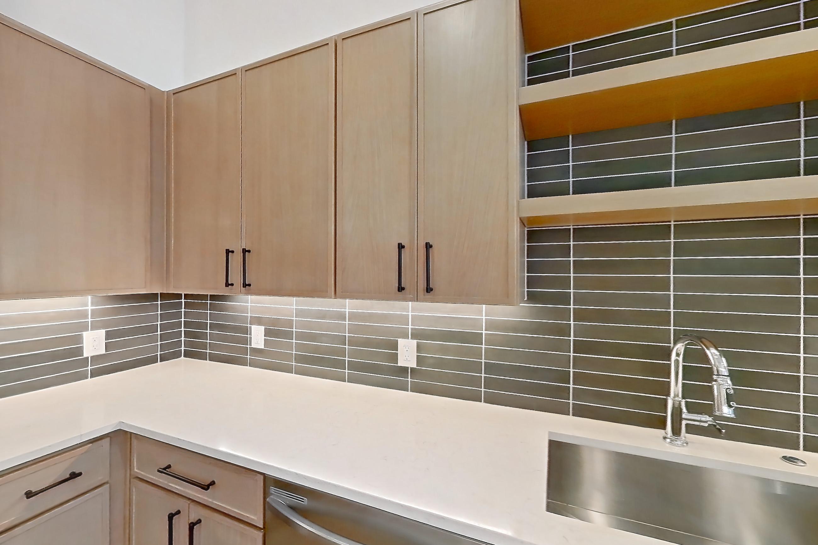 Kitchen with dishwasher, electric range, light countertops, light stone countertops, light wood-finish flooring, oven/range, and stainless steel appliances, Apartment 1109 at Cortland Galleria