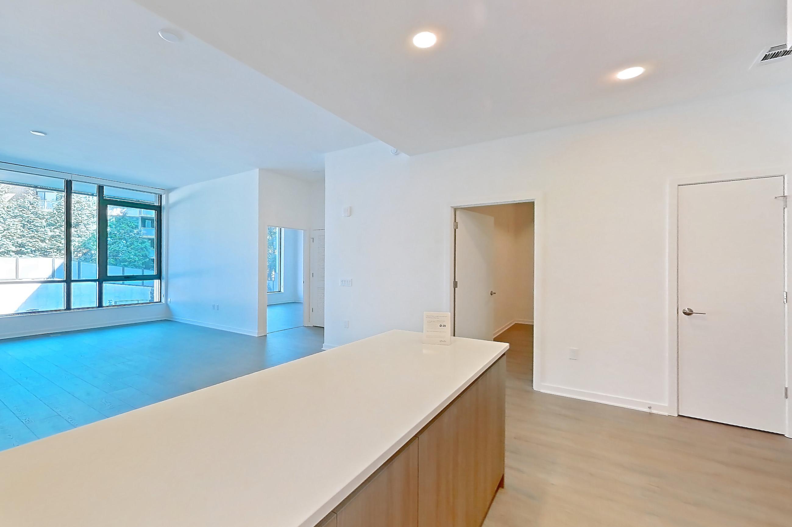 Kitchen with gas range, light stone countertops, light wood-finish flooring, oven/range, and stainless steel appliances, Apartment 0112 at Aerie