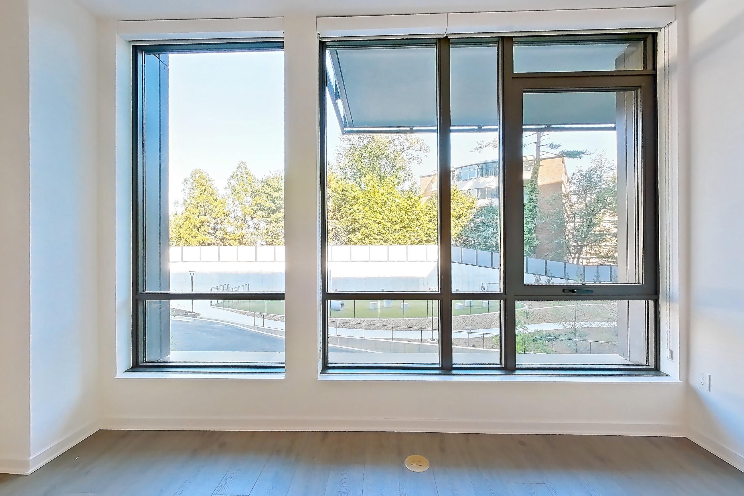 Living room with dark wood-finish flooring, Apartment 0112 at Aerie