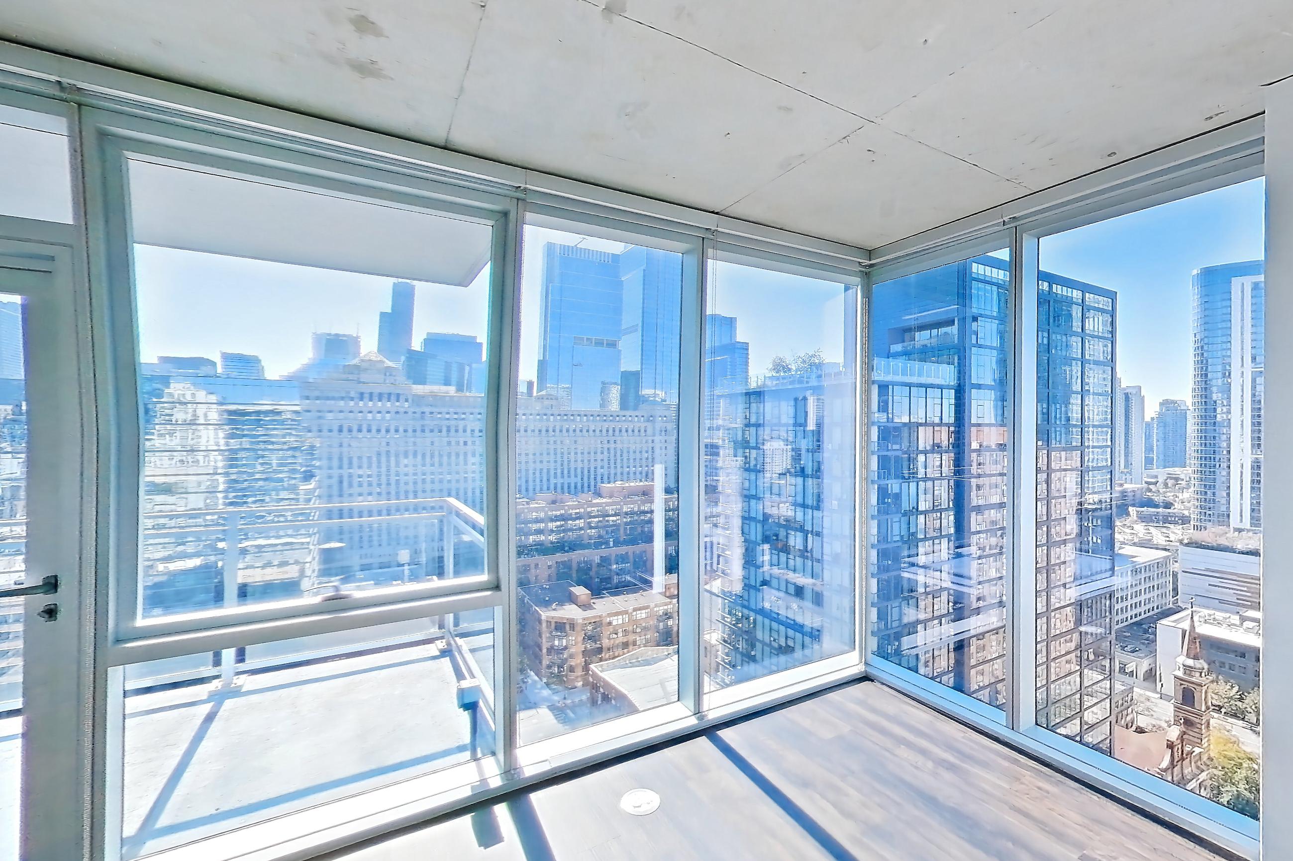 Living room with city view, dark wood-finish flooring, and skyline view, Apartment 2302 at 220 WIL
