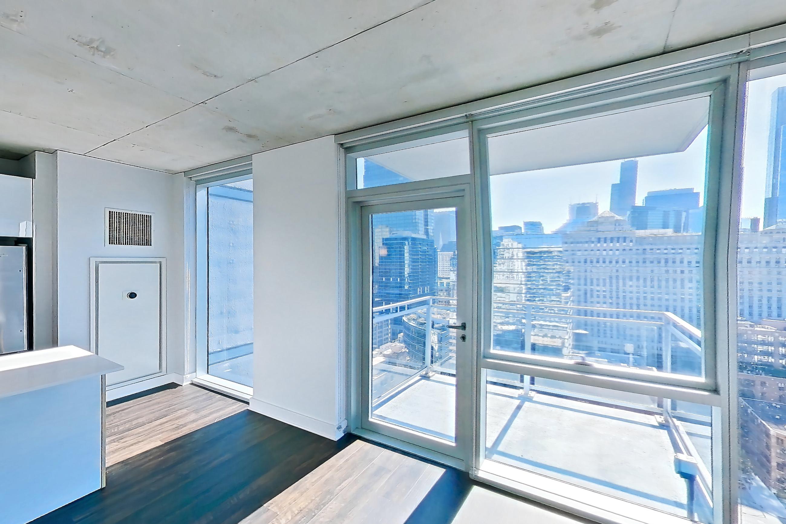 Living room with city view, dark wood-finish flooring, and skyline view, Apartment 2302 at 220 WIL