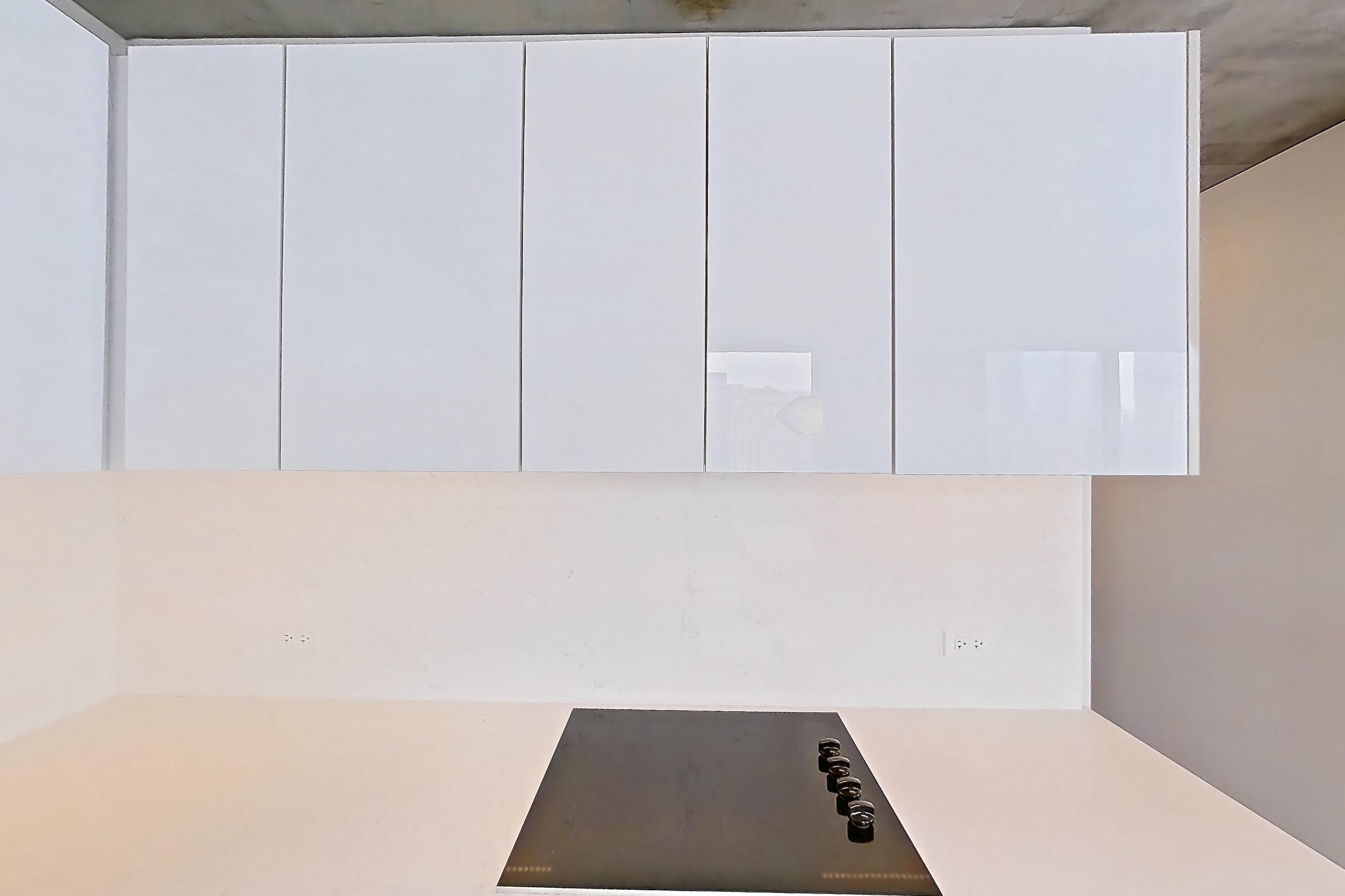 Kitchen with black appliances, cooktop, dark wood-finish flooring, electric cooktop, and light stone countertops, Apartment 1810 at 220 WIL