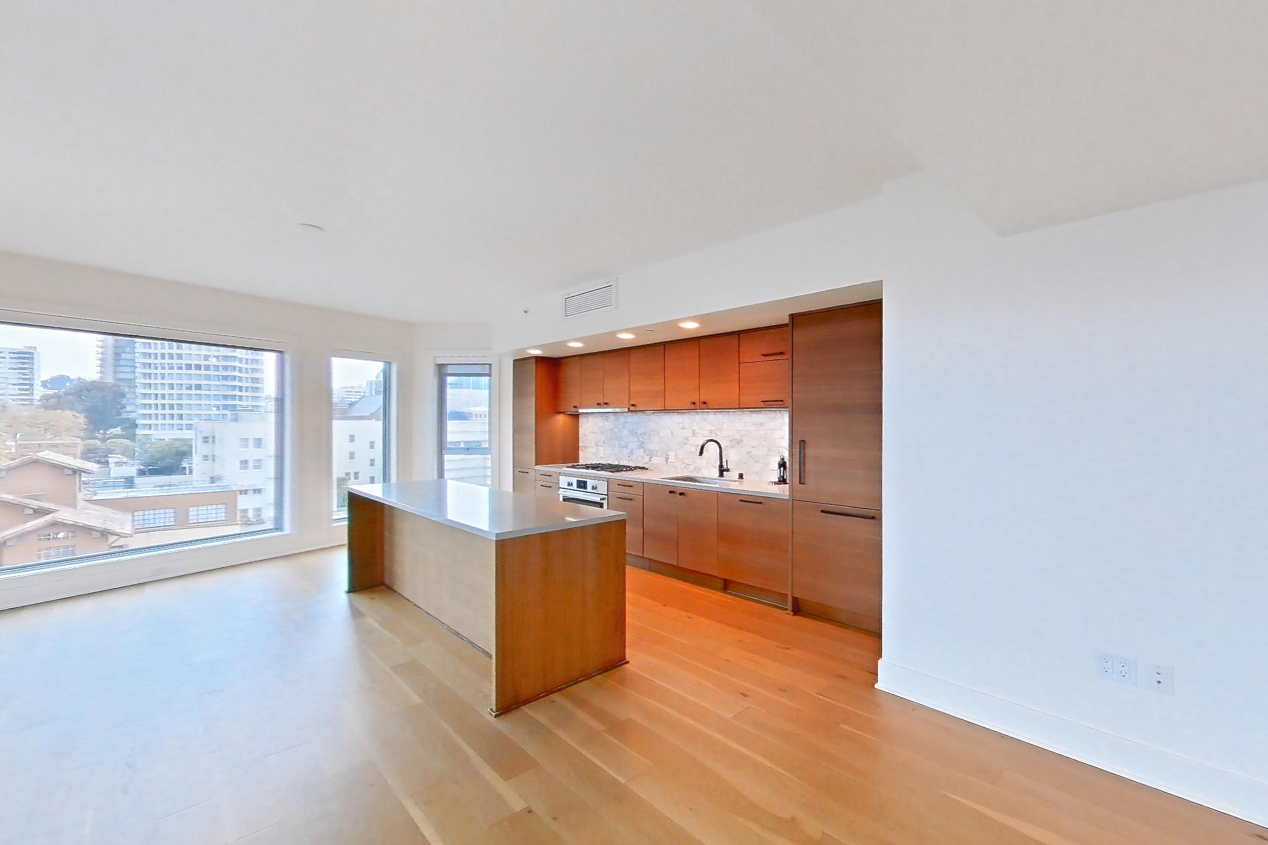 Living room with cooktop, gas cooktop, light countertops, light wood-finish flooring, oven/range, stainless steel appliances, and wood-finish flooring, Apartment PH2 at Konrad on the Park