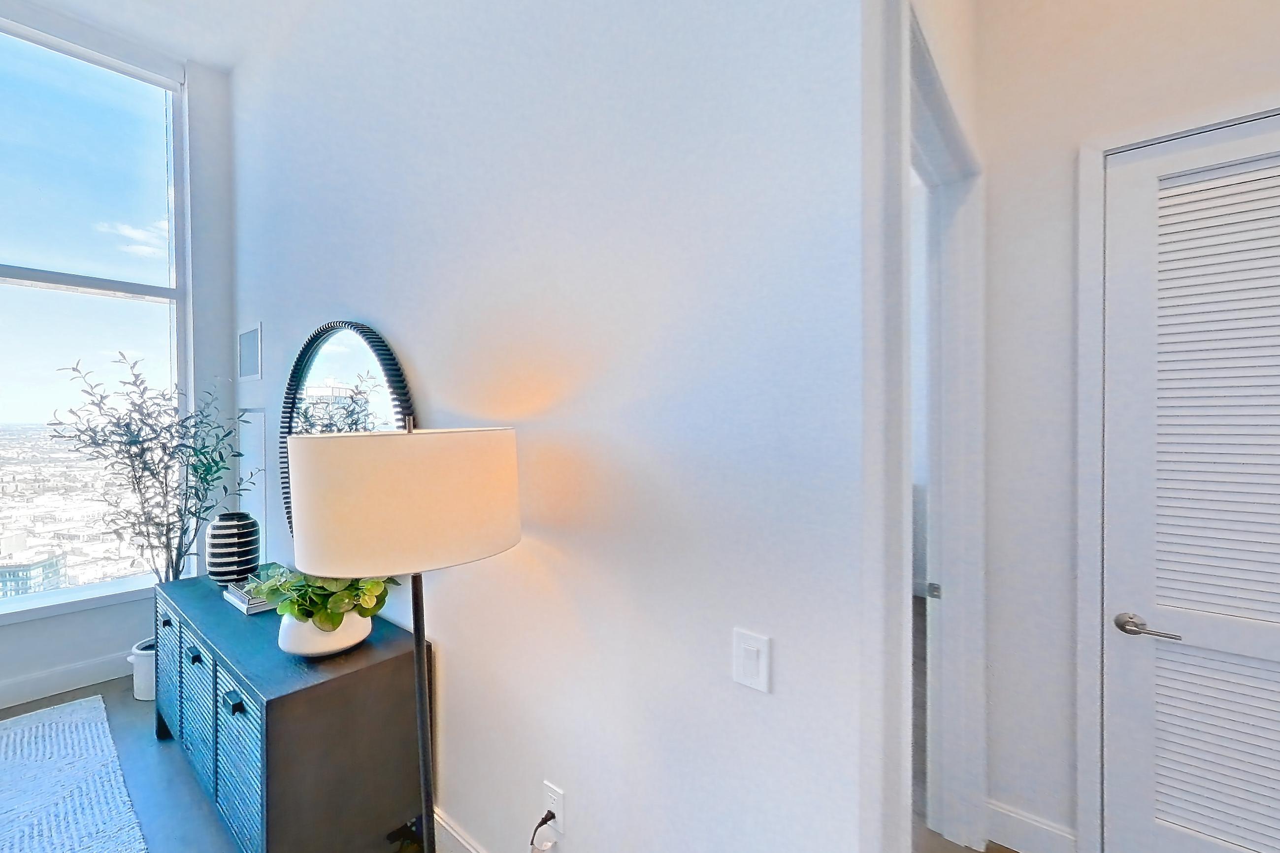 Living room with gas range, light wood-finish flooring, oven/range, and stainless steel appliances, Apartment PH2G at Lumen