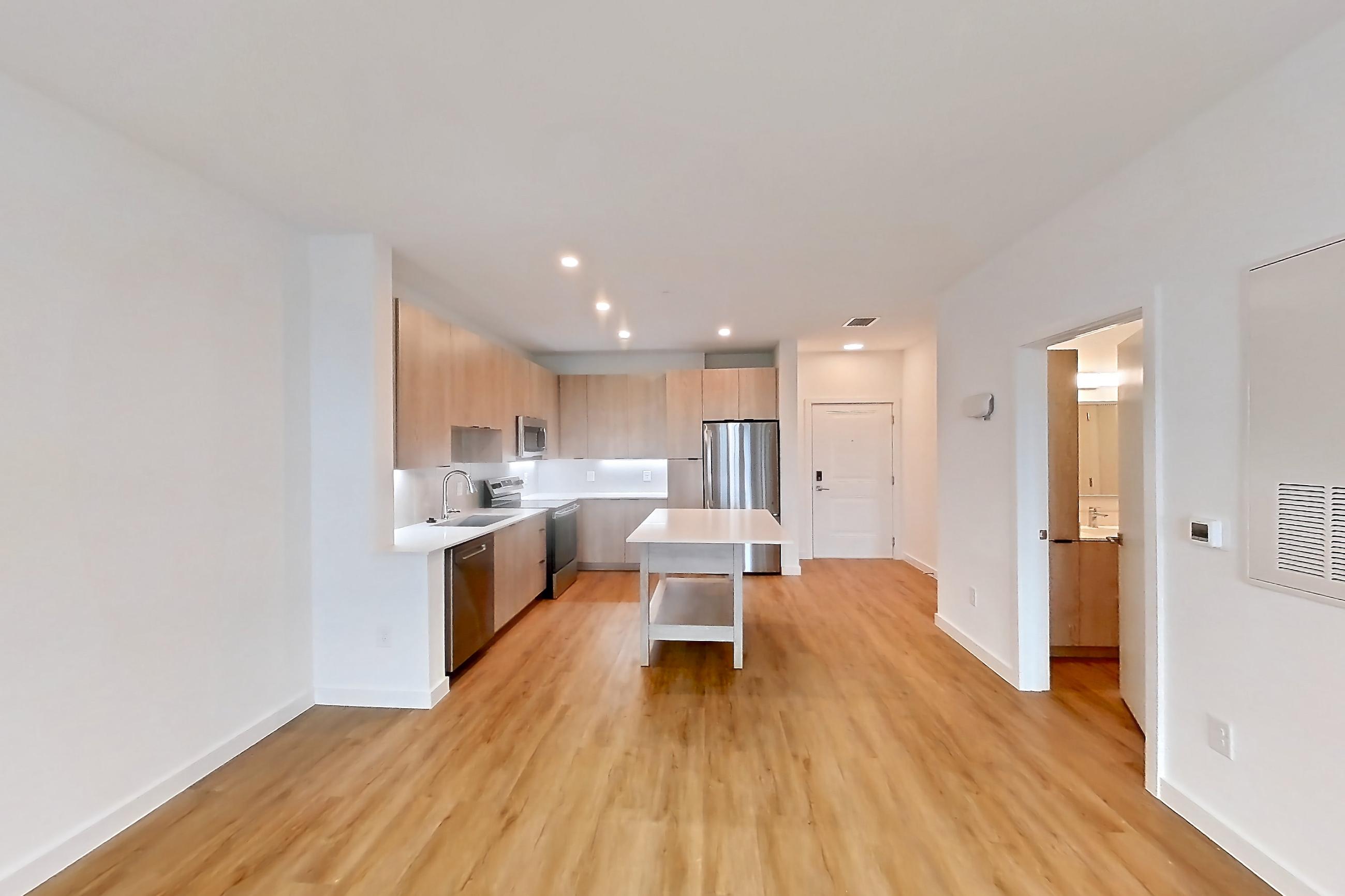 Living space with dishwasher, electric range, light countertops, light wood-finish flooring, oven/range, and stainless steel appliances, Apartment 1310 at Caroline Anclote Harbor