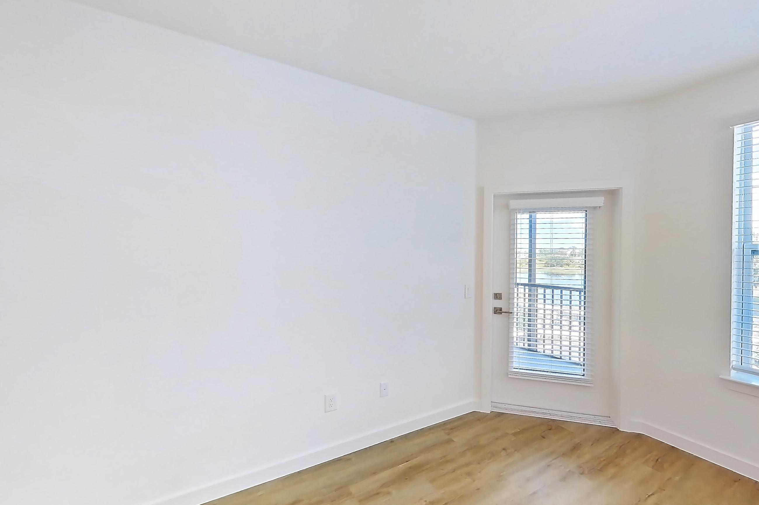 Living space with dishwasher, electric range, light countertops, light wood-finish flooring, oven/range, refrigerator, and stainless steel appliances, Apartment 1313 at Caroline Anclote Harbor
