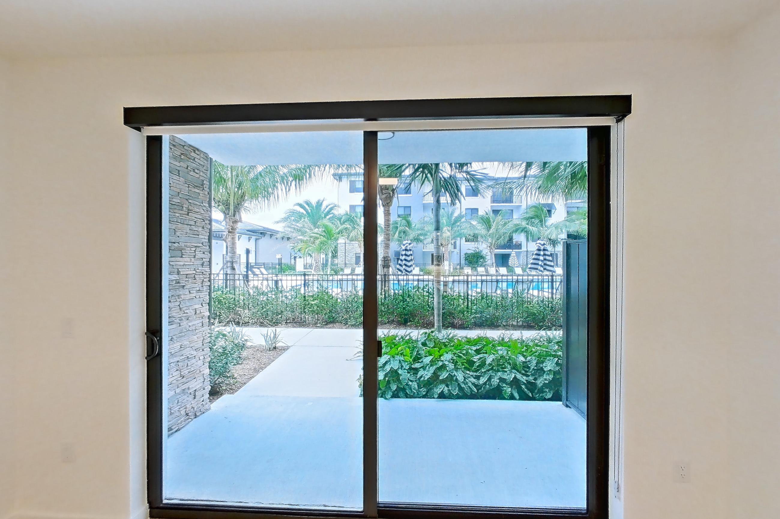 Living room with light wood-finish flooring, Apartment 101 at Caroline Pompano Beach