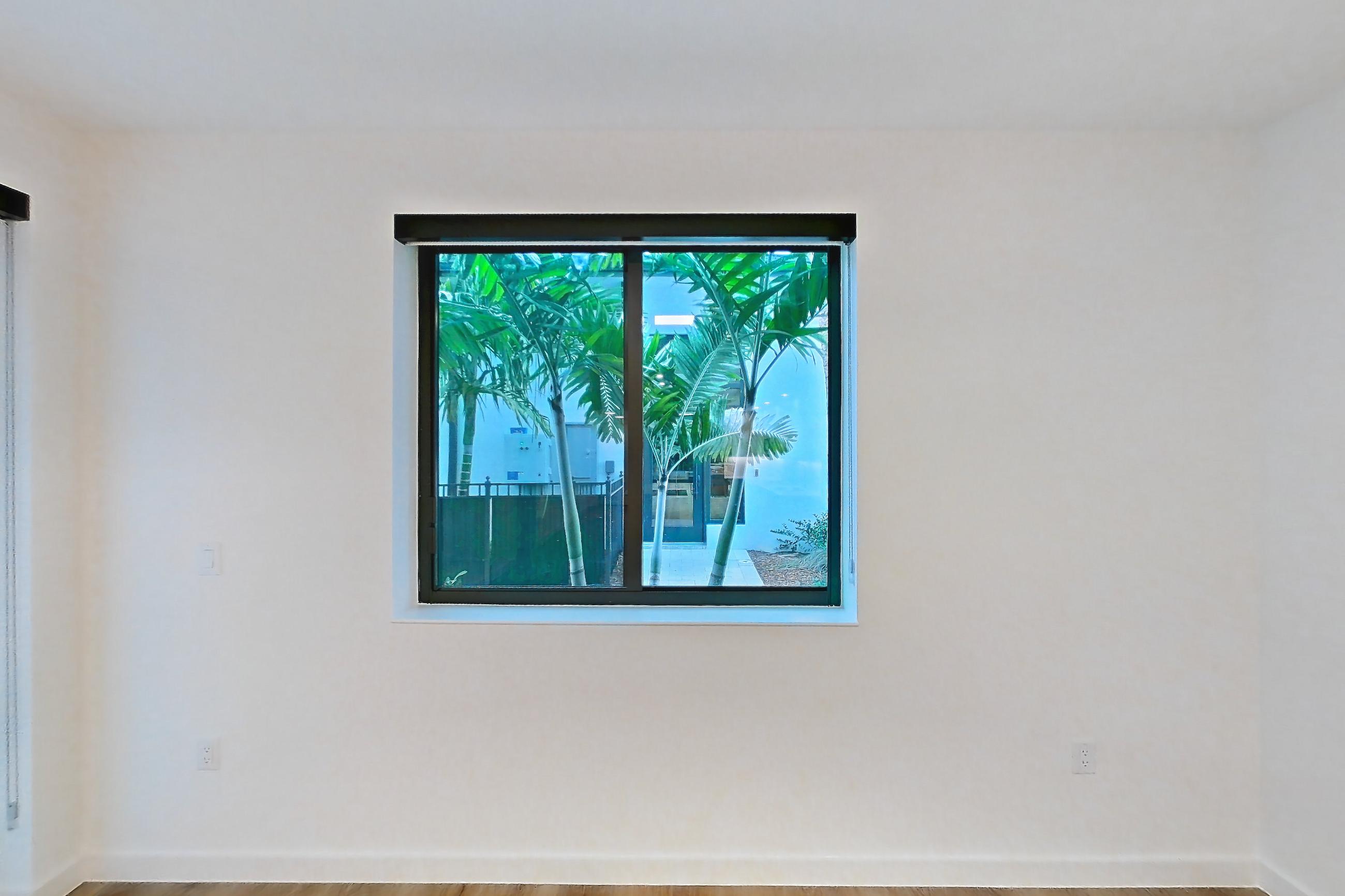 Living room with light wood-finish flooring, Apartment 106 at Caroline Pompano Beach