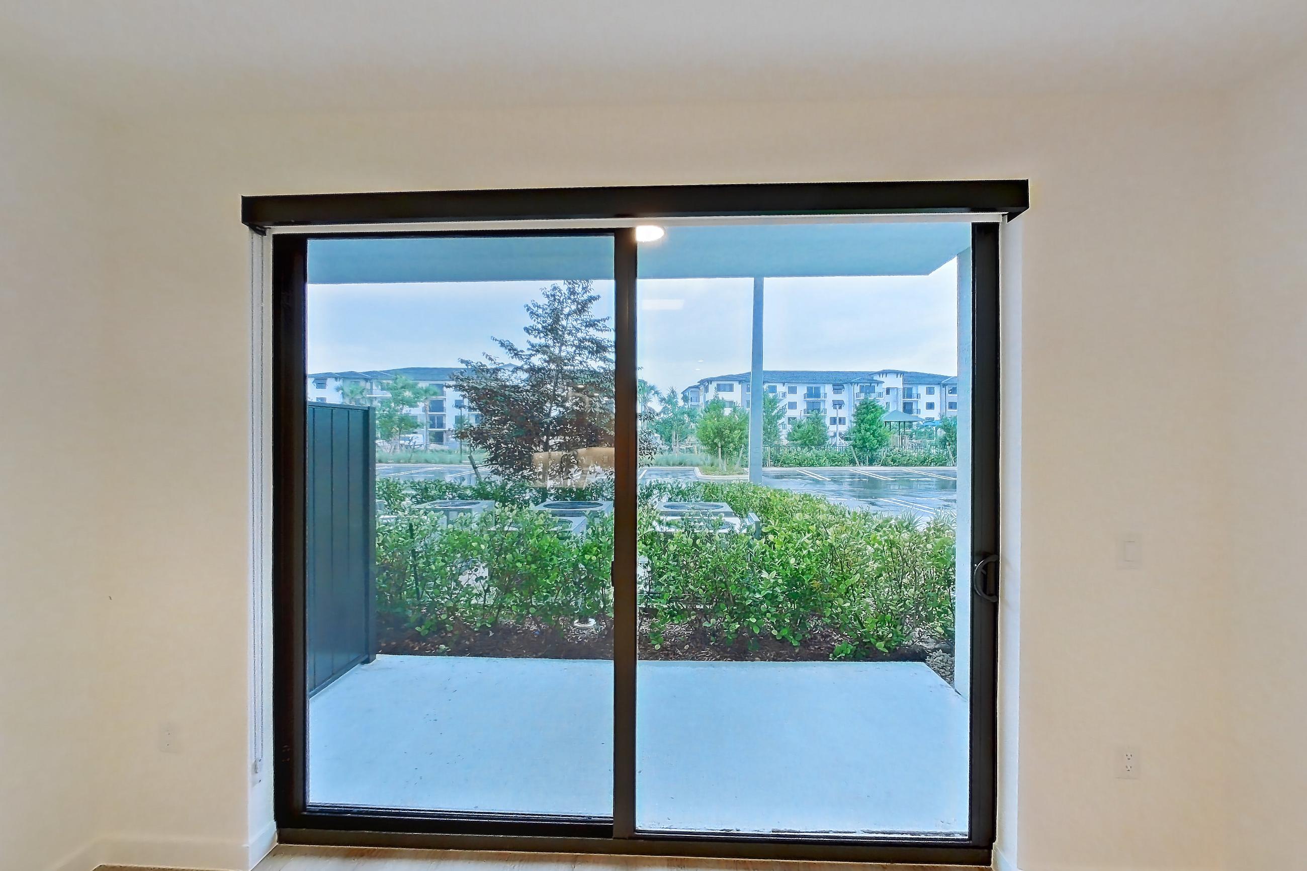 Living room with light wood-finish flooring, Apartment 111 at Caroline Pompano Beach