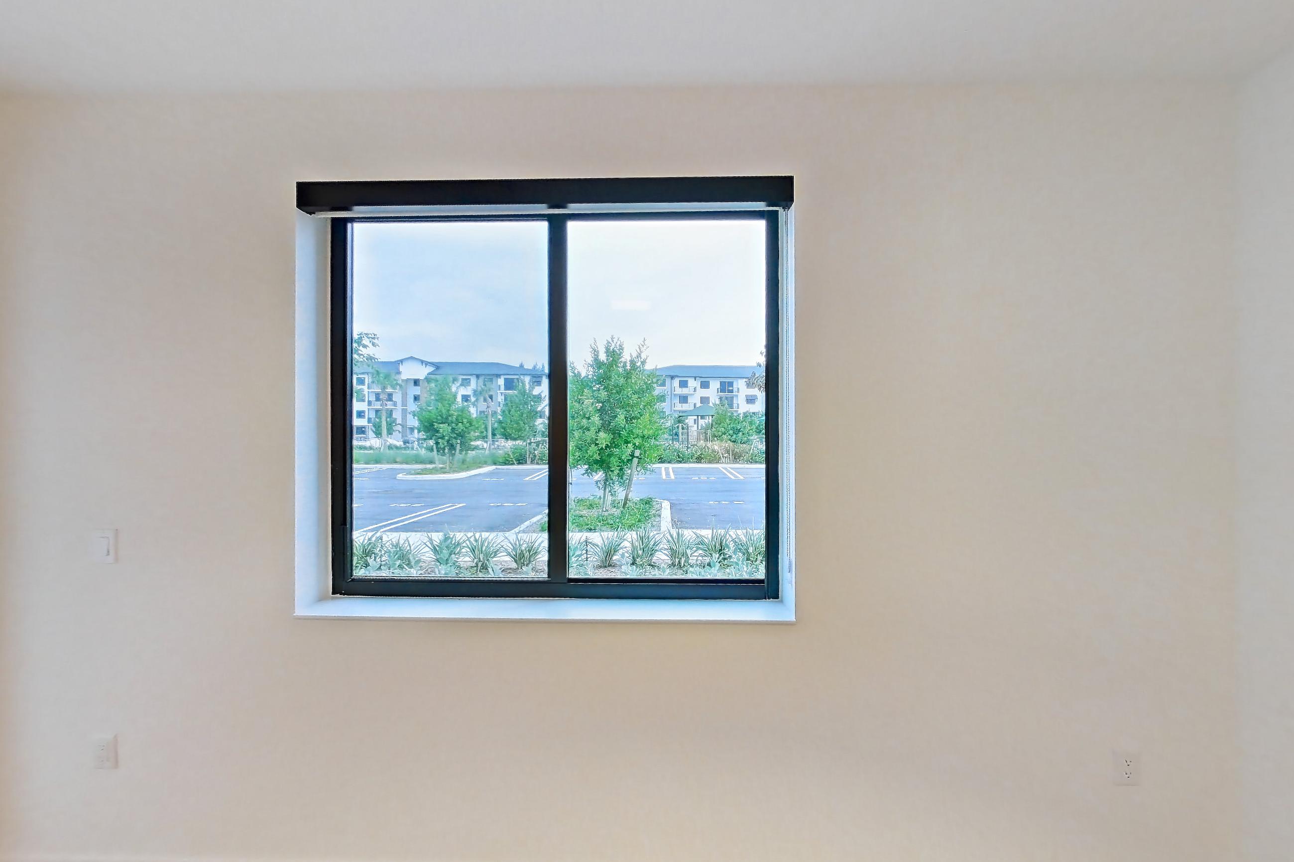 Living room with light wood-finish flooring, Apartment 112 at Caroline Pompano Beach