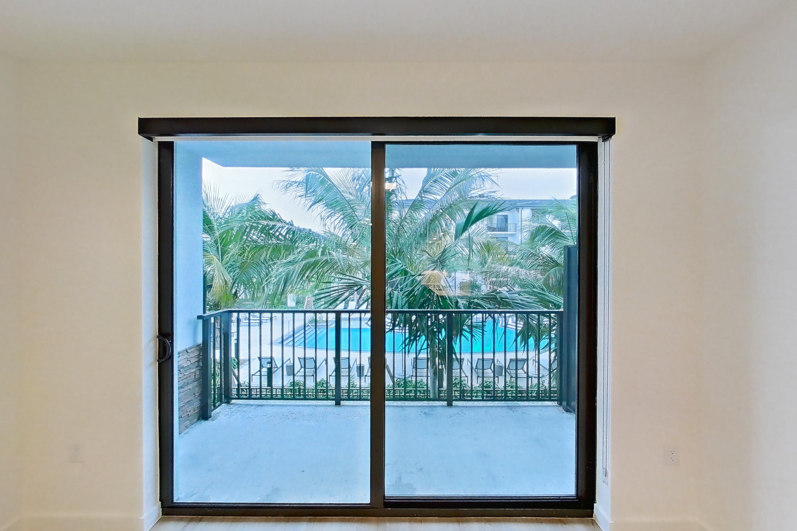 Living room with light wood-finish flooring, Apartment 201 at Caroline Pompano Beach