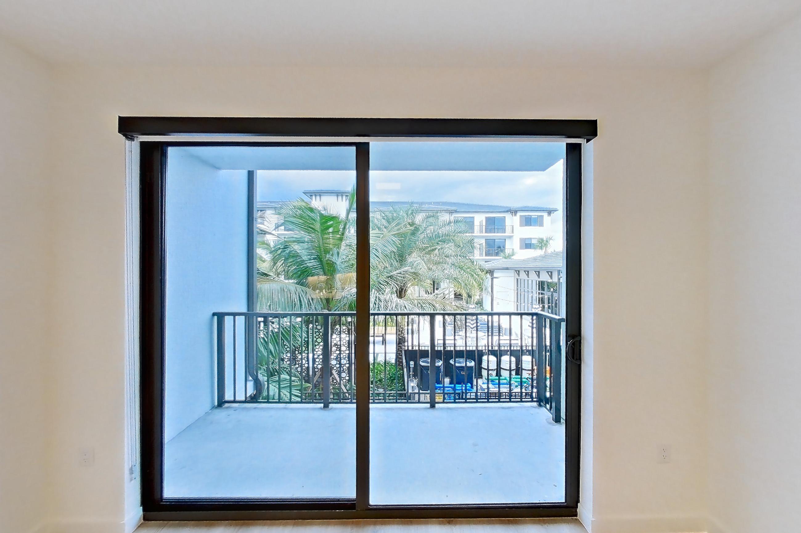 Living room with light wood-finish flooring, Apartment 205 at Caroline Pompano Beach