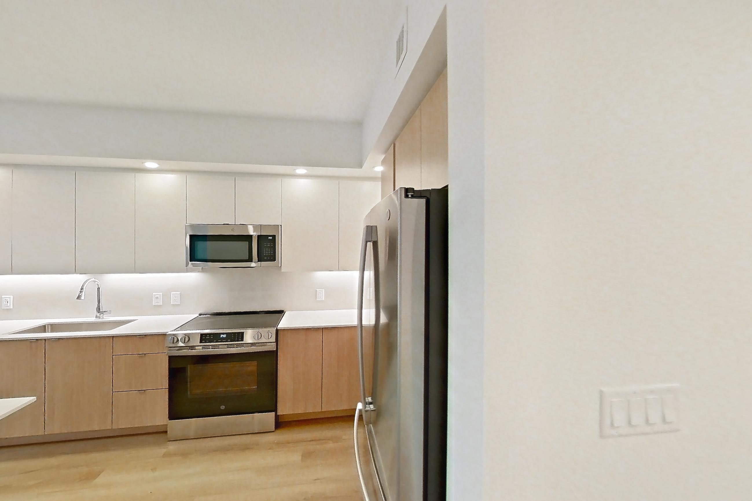 Kitchen entryway in Apartment 206 at Caroline Pompano Beach, C1 floor plan