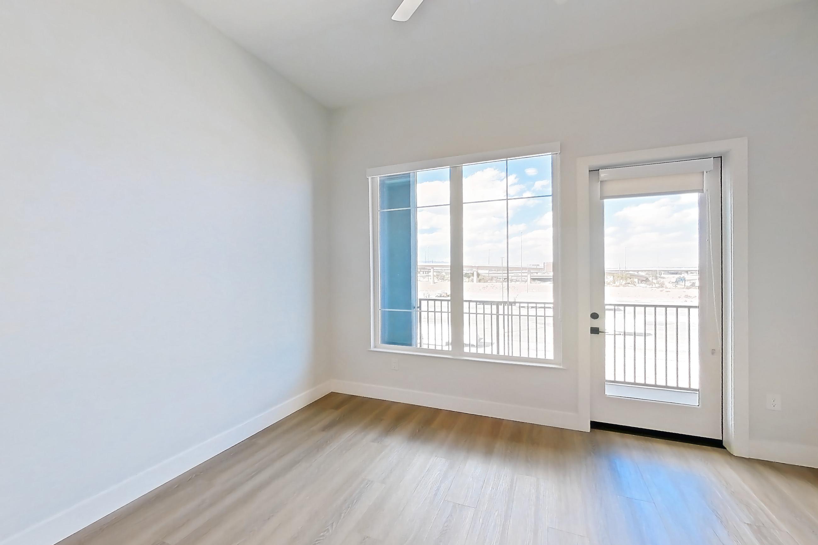 Living room with gas range, light stone countertops, light wood-finish flooring, oven/range, and stainless steel appliances, Apartment 568 at Bria
