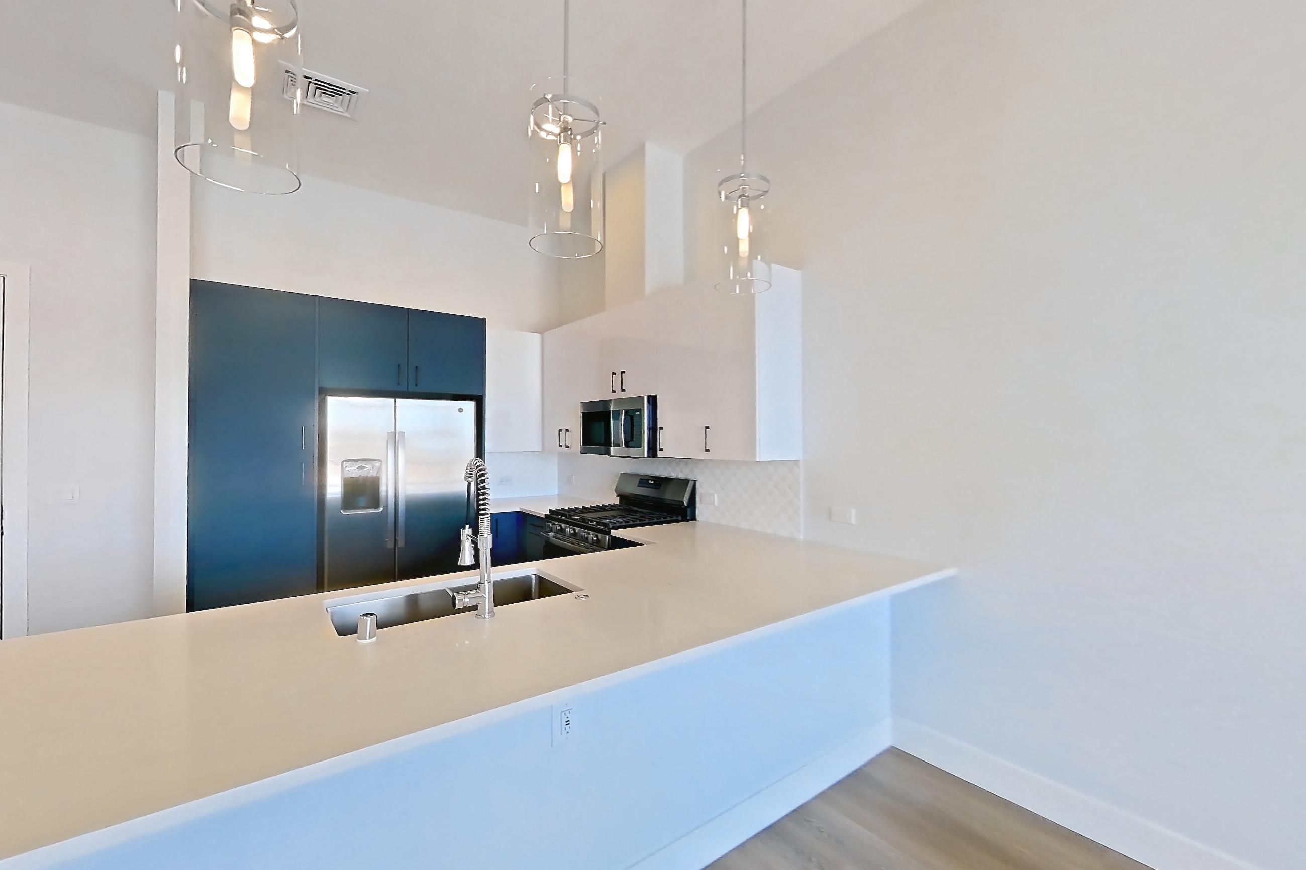 Living room with gas range, light stone countertops, light wood-finish flooring, oven/range, and stainless steel appliances, Apartment 568 at Bria