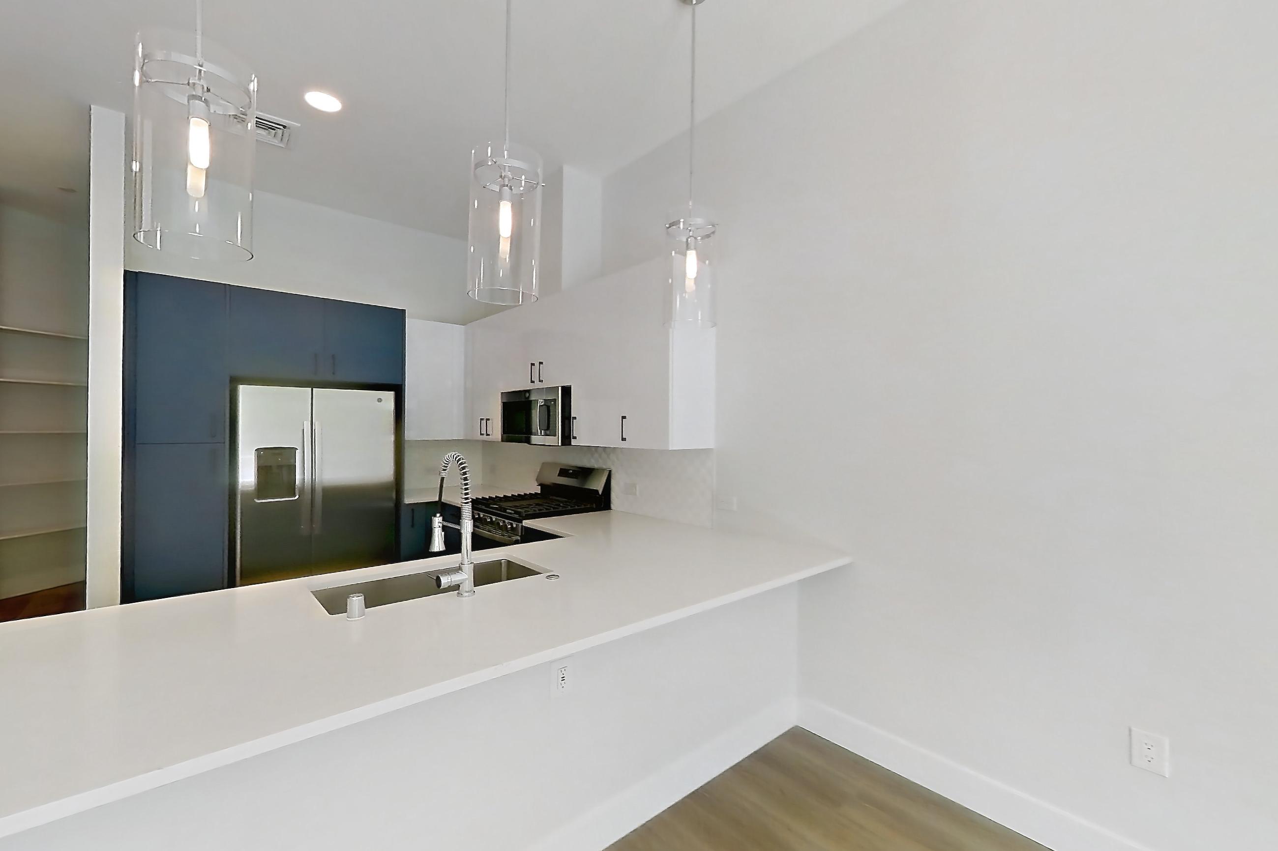 Living room with gas range, light wood-finish flooring, oven/range, and stainless steel appliances, Apartment 130 at Bria