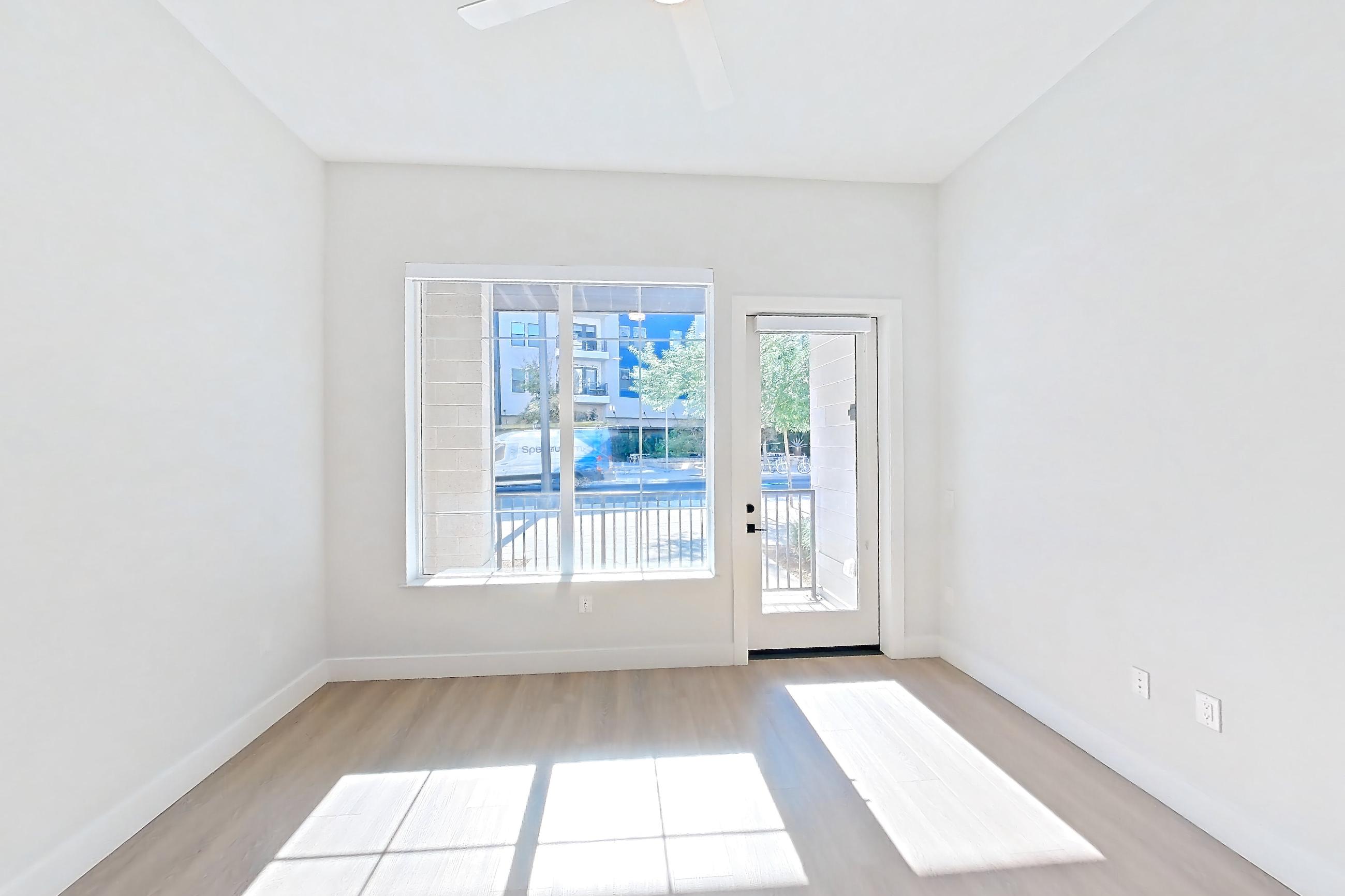 Living room with light wood-finish flooring, Apartment 116 at Bria