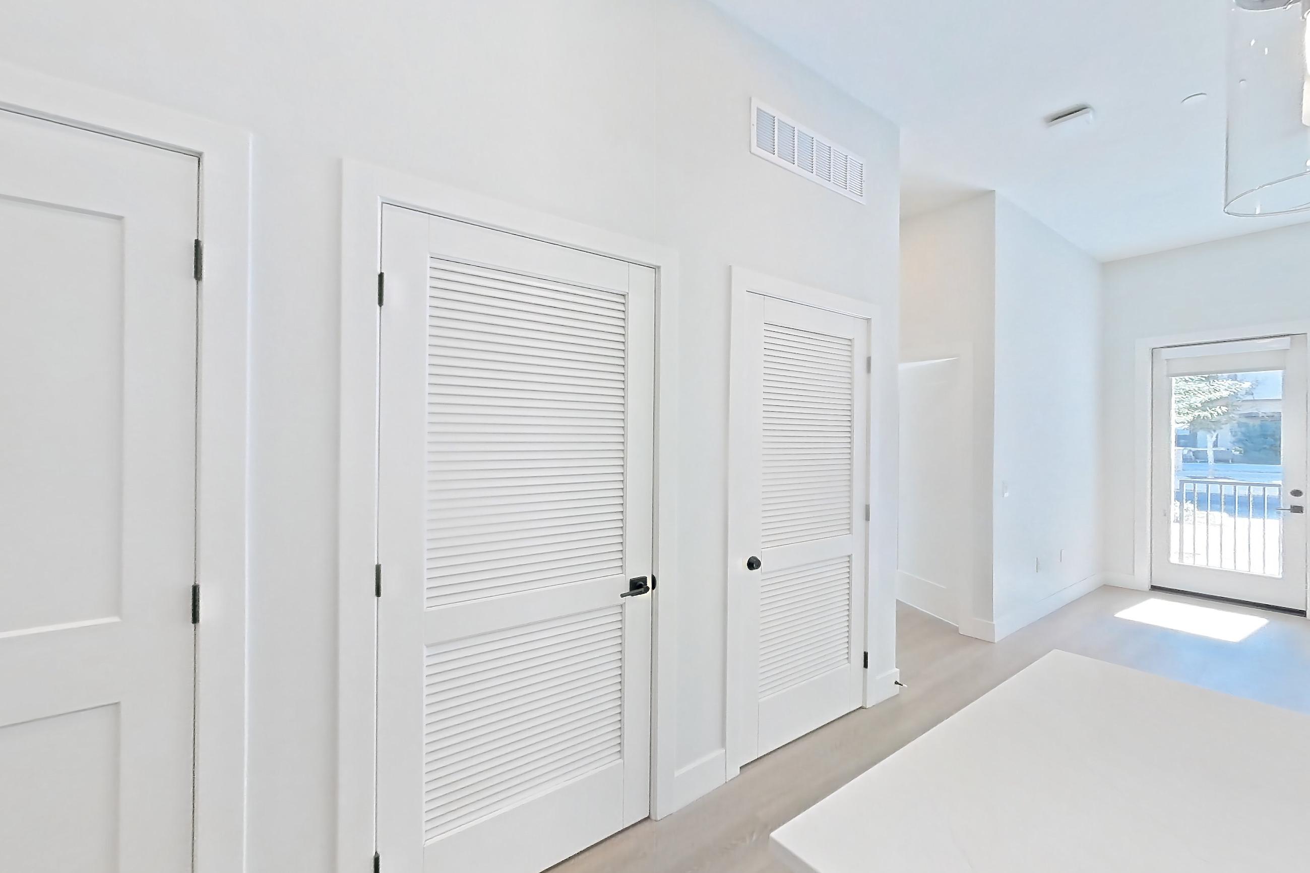 Kitchen with dishwasher, gas range, light countertops, light stone countertops, light wood-finish flooring, microwave, oven/range, refrigerator, stainless steel appliances, and water & ice dispenser, Apartment 118 at Bria