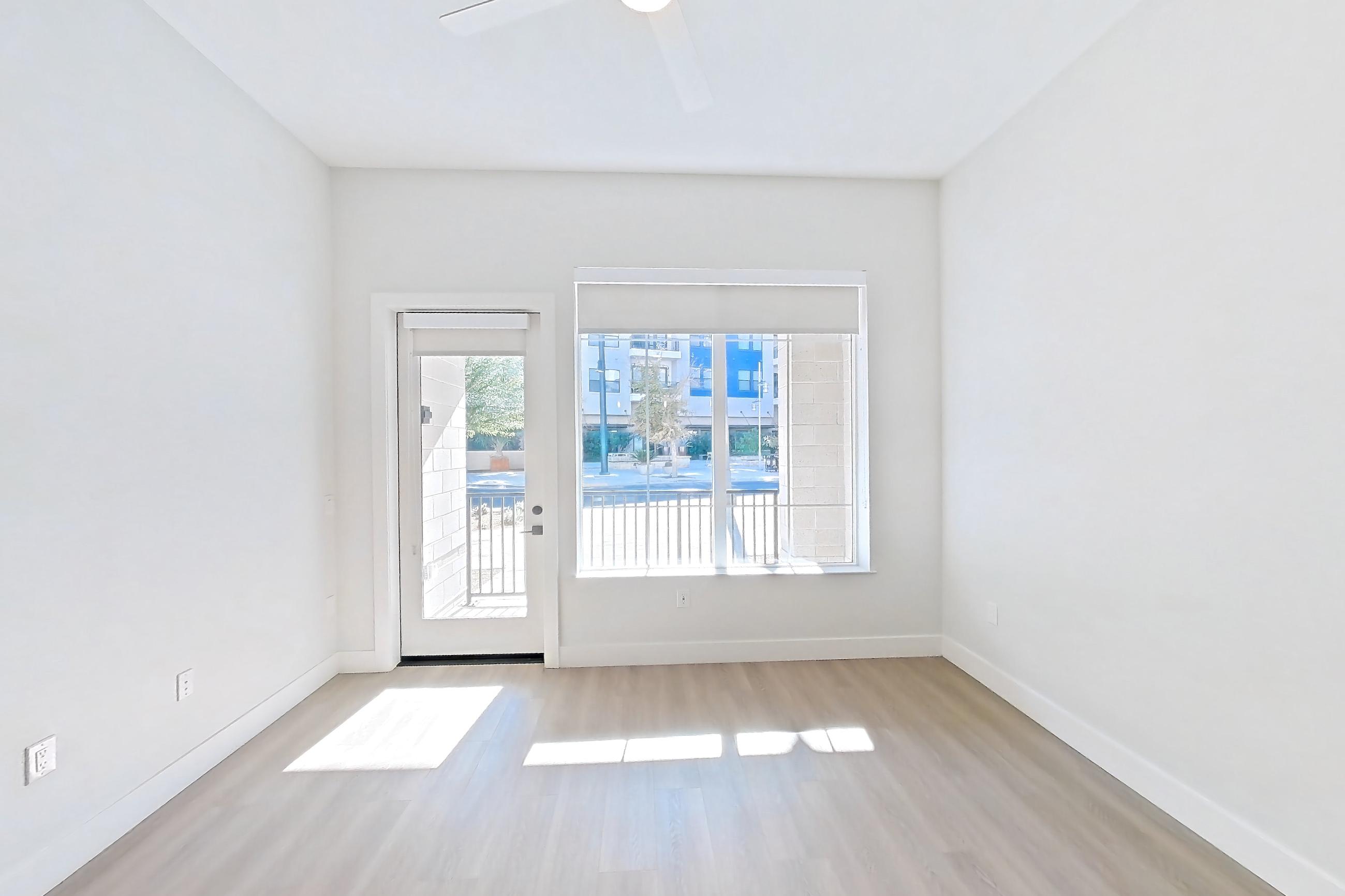 Living room with light wood-finish flooring, Apartment 118 at Bria