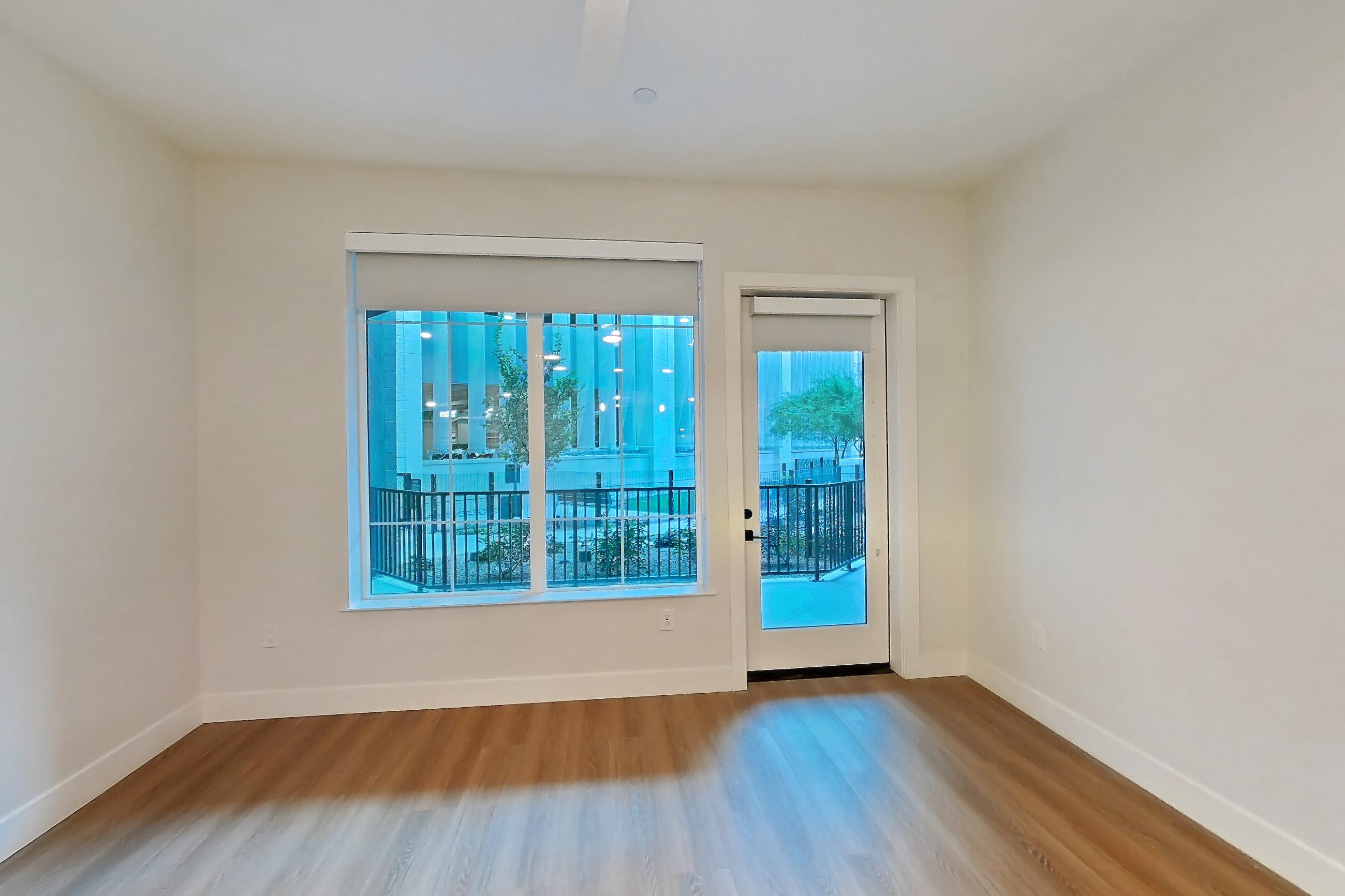 Living room with light wood-finish flooring, Apartment 111 at Bria
