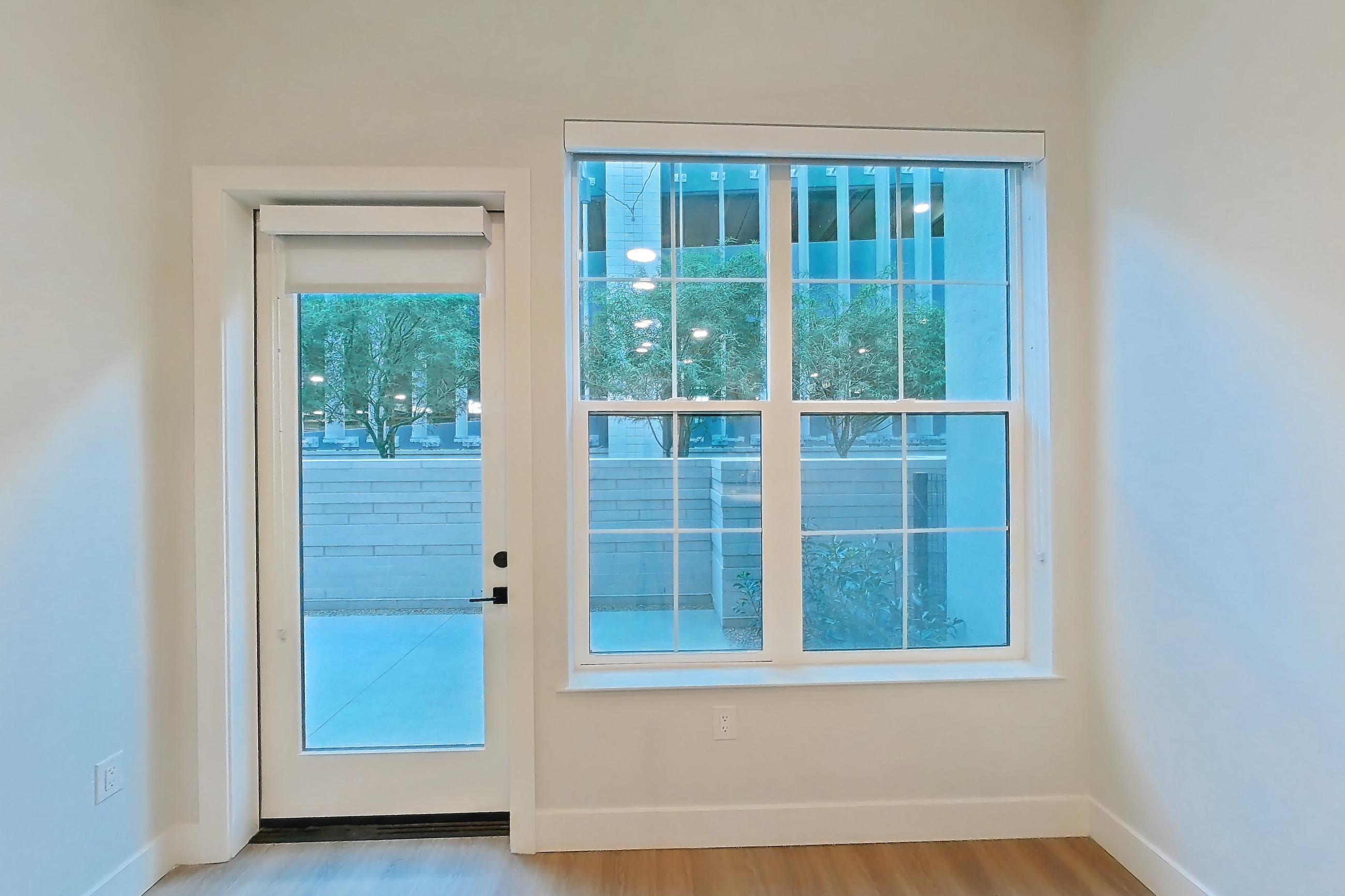 Living room with light wood-finish flooring, Apartment 117 at Bria