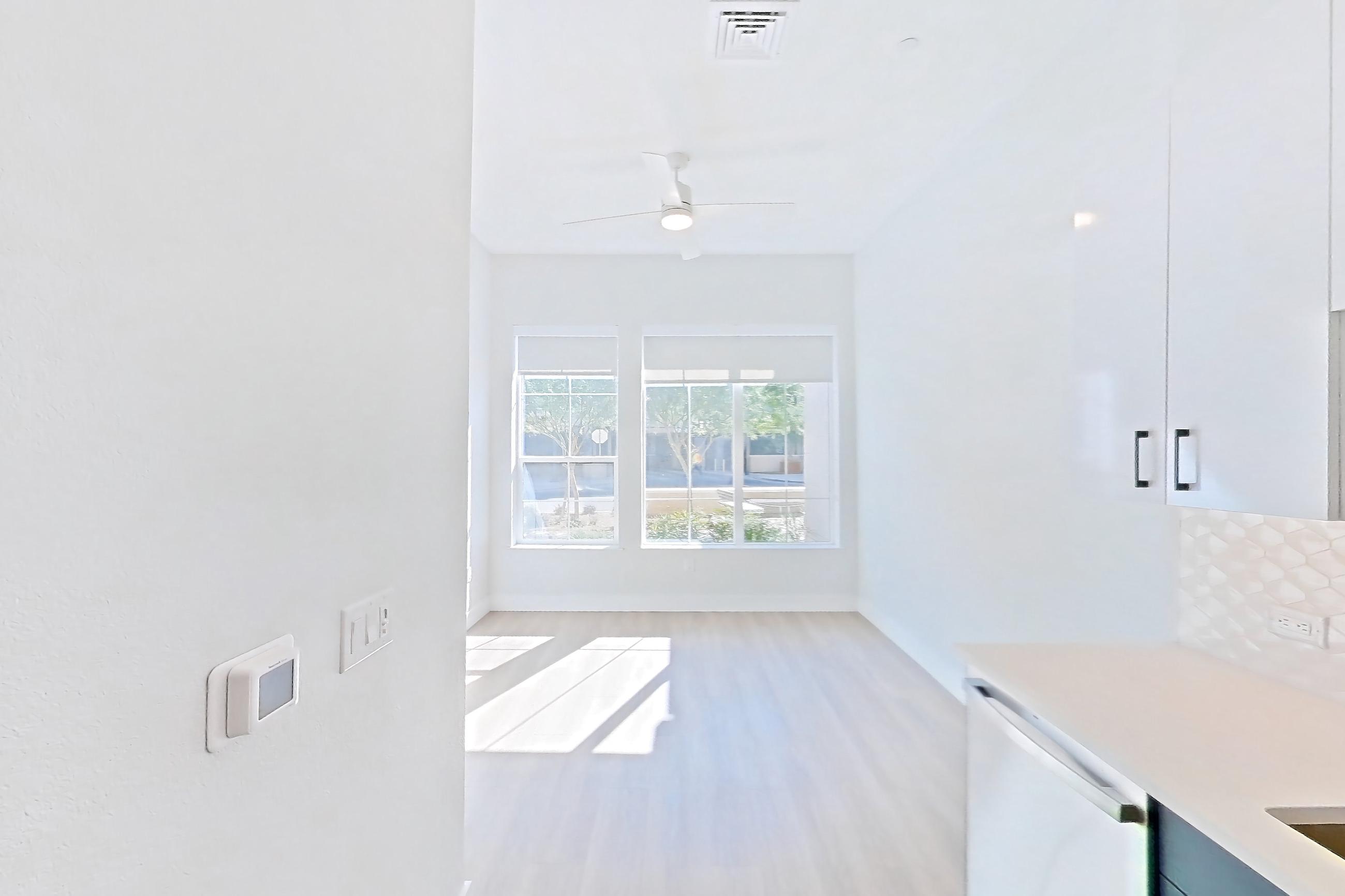 Kitchen with gas range, light countertops, light stone countertops, light wood-finish flooring, microwave, oven/range, refrigerator, stainless steel appliances, and water & ice dispenser, Apartment 122 at Bria