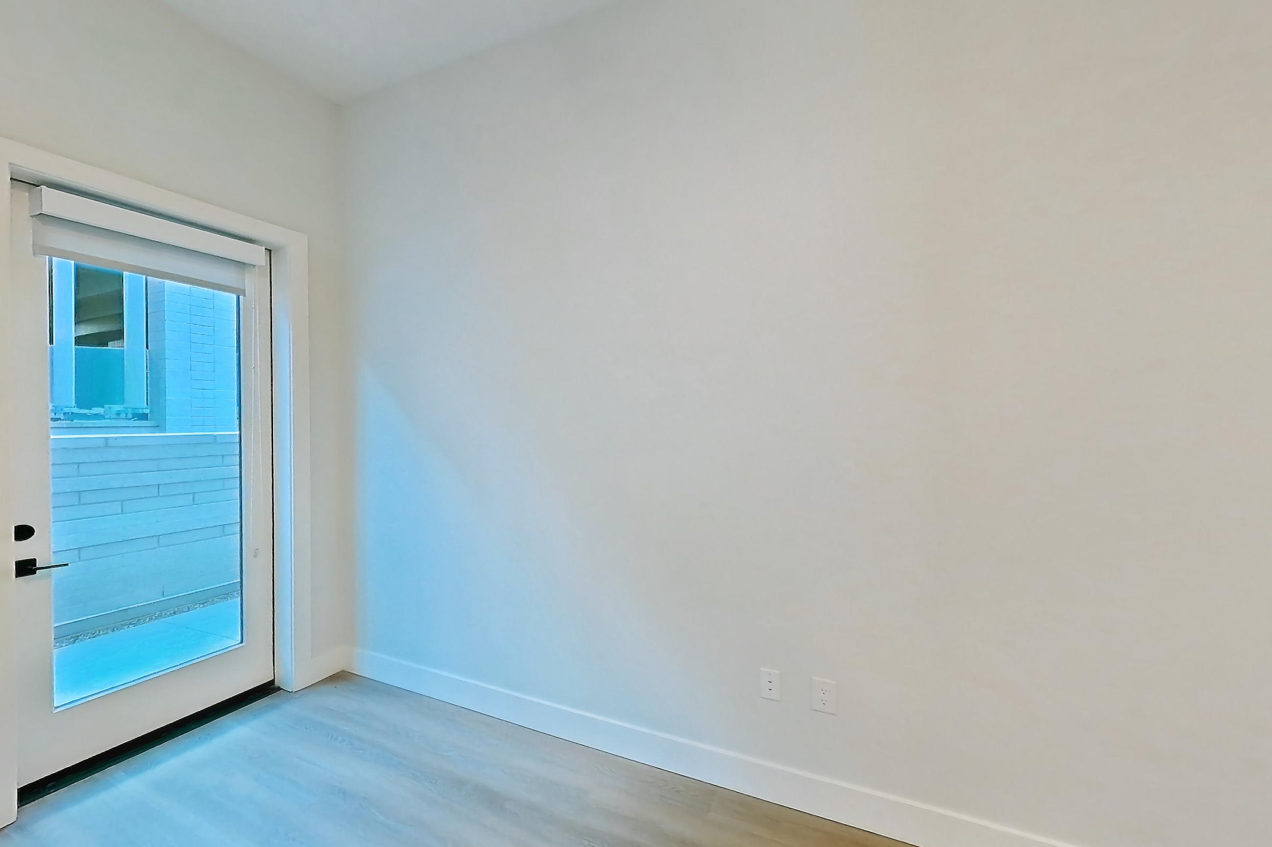 Living room with light wood-finish flooring, Apartment 119 at Bria