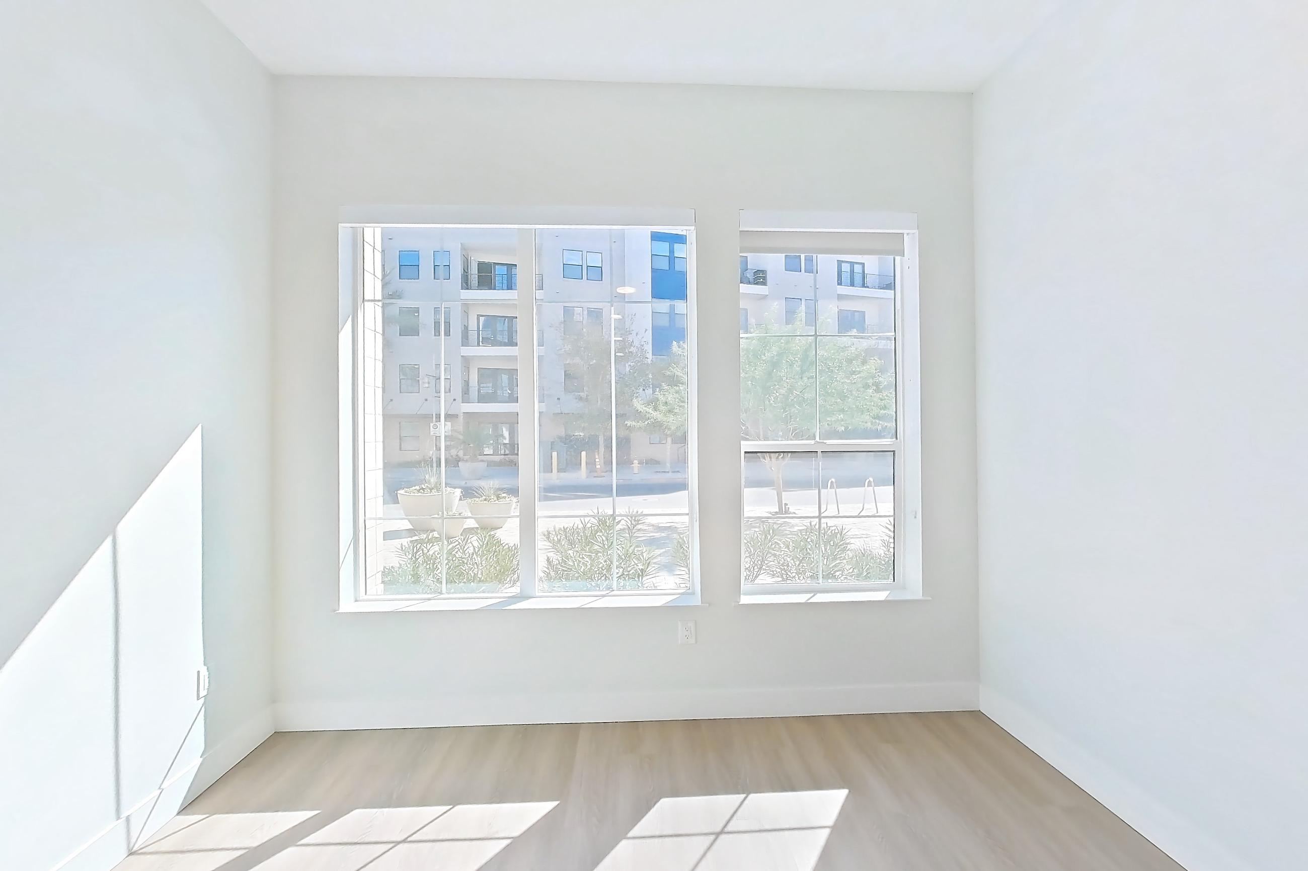 Living room with light wood-finish flooring, Apartment 132 at Bria