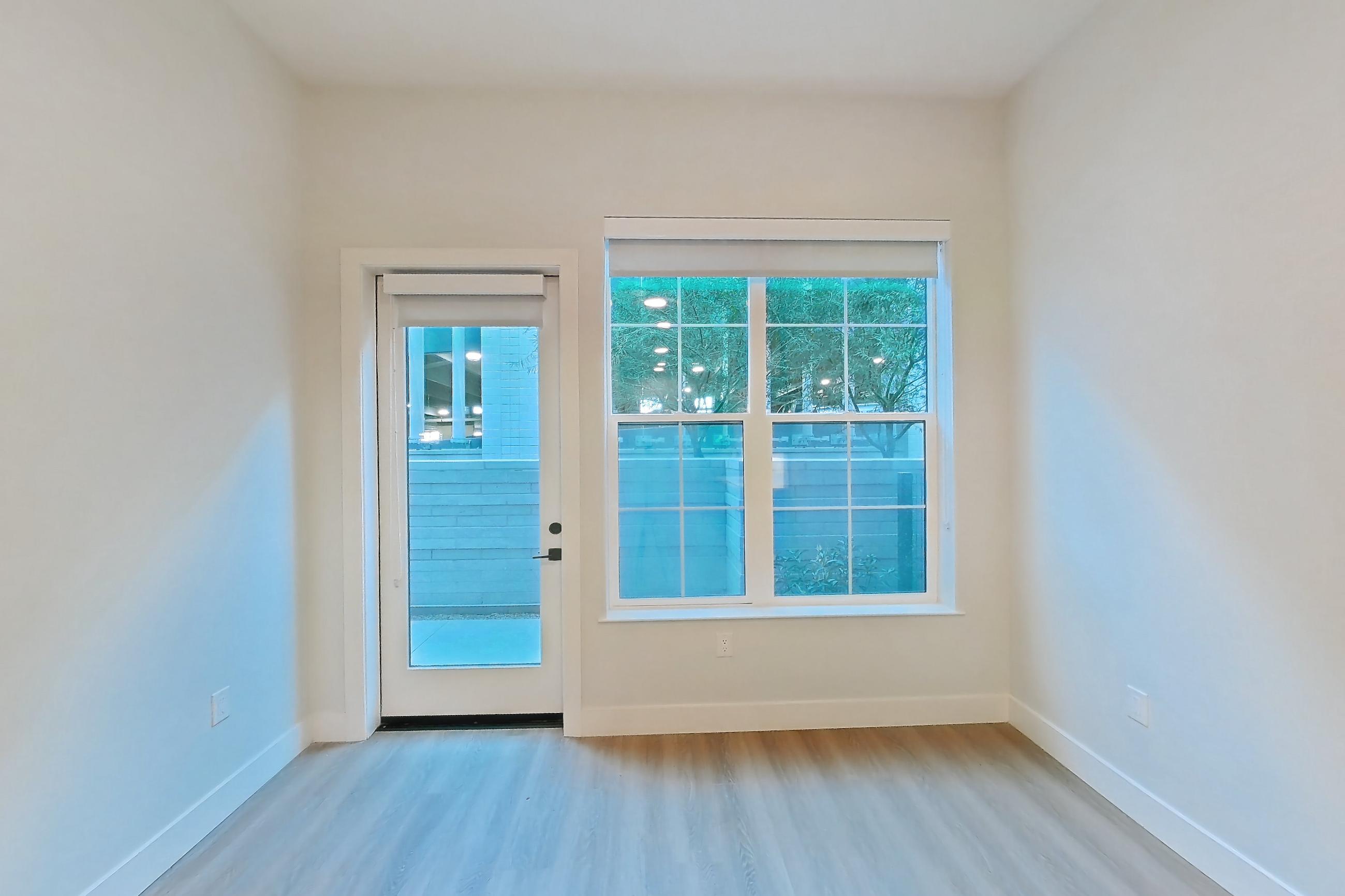 Living room with light wood-finish flooring, Apartment 115 at Bria