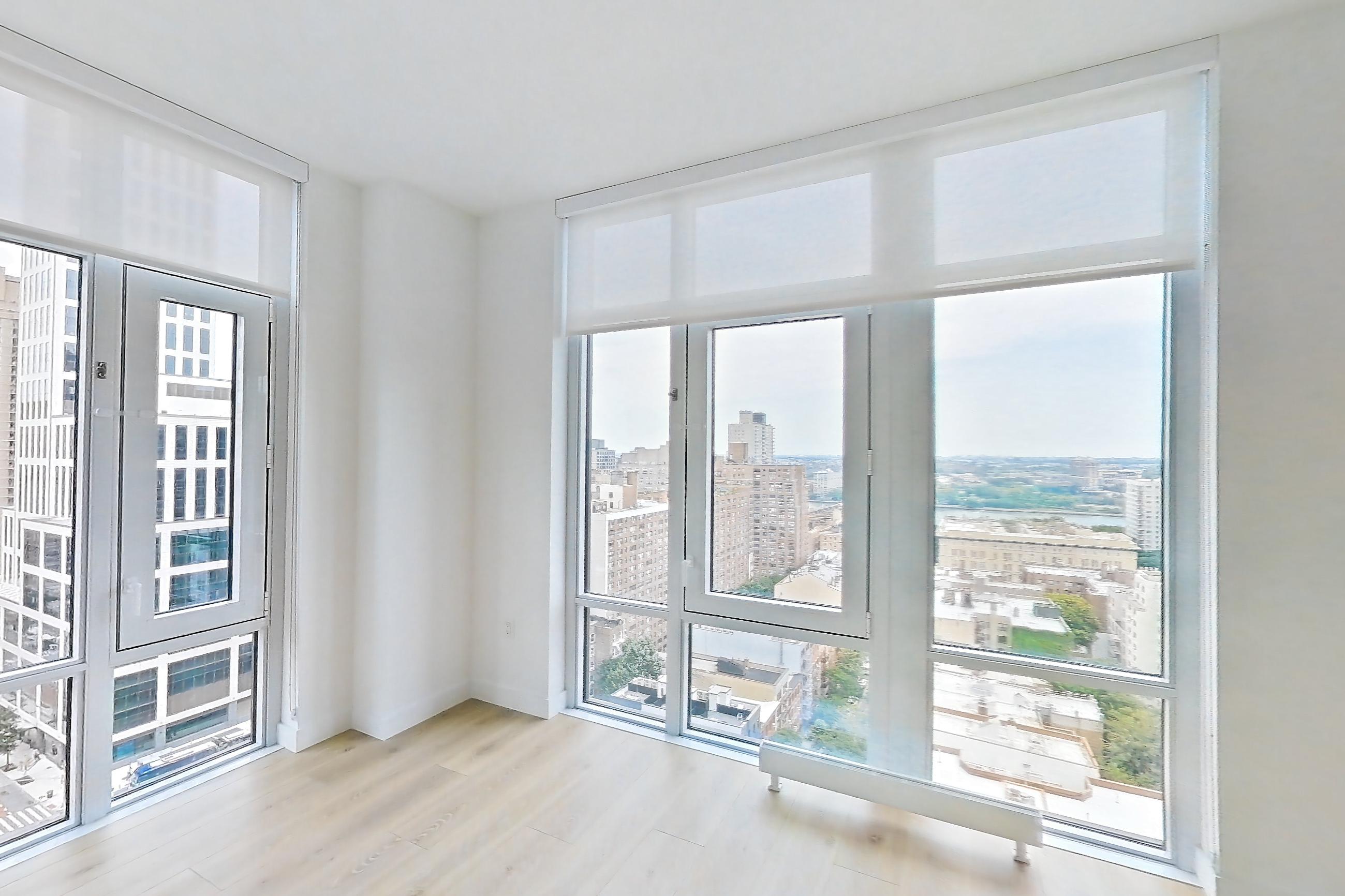 Living room with city view, gas cooktop, and light wood-finish flooring, Apartment 19B at Maison 78