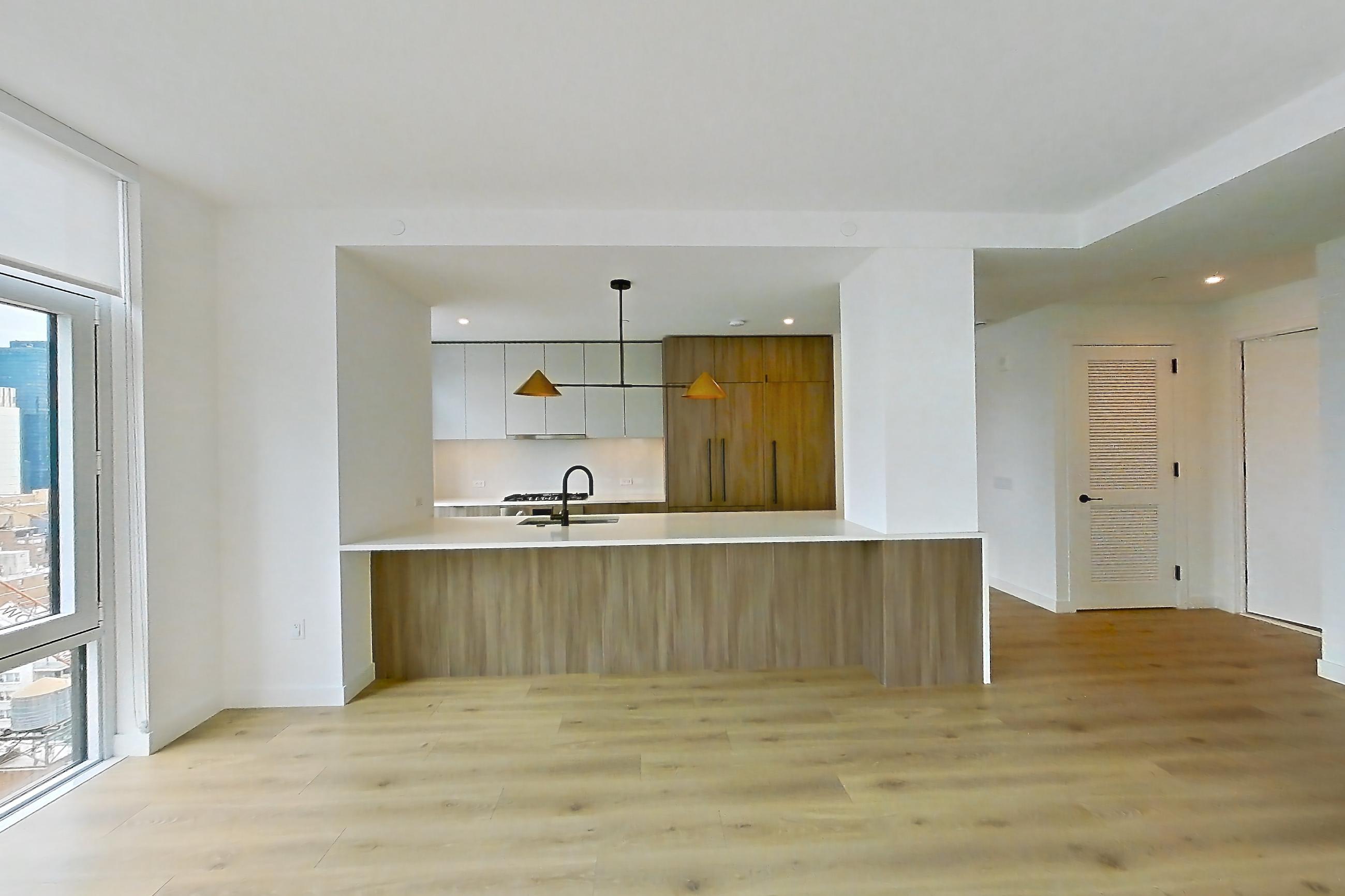Living room with city view, gas cooktop, and light wood-finish flooring, Apartment 19B at Maison 78