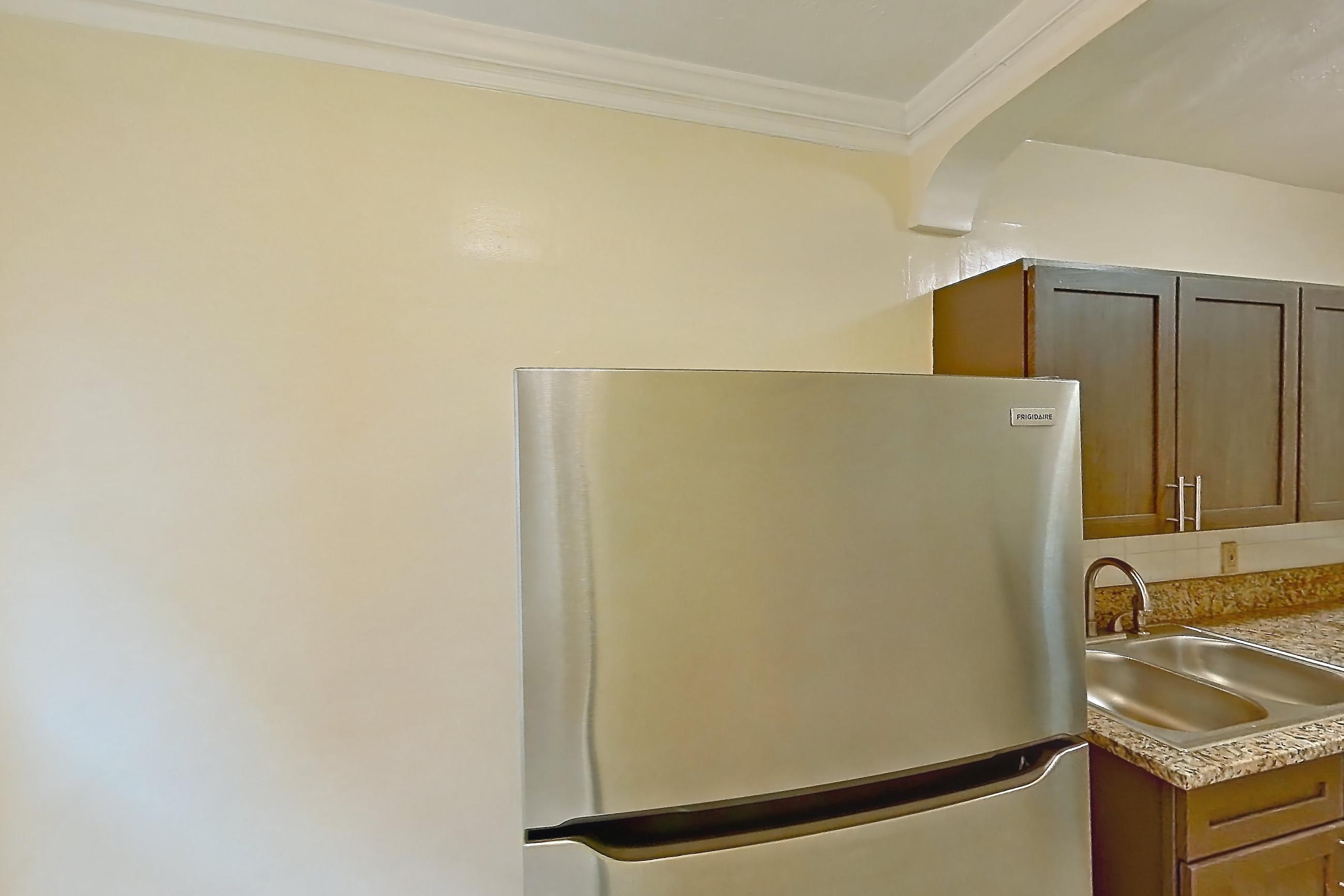 Kitchen with gas range, light stone countertops, light tile flooring, oven/range, refrigerator, and stainless steel appliances, Apartment MVI-14 at Mapleview