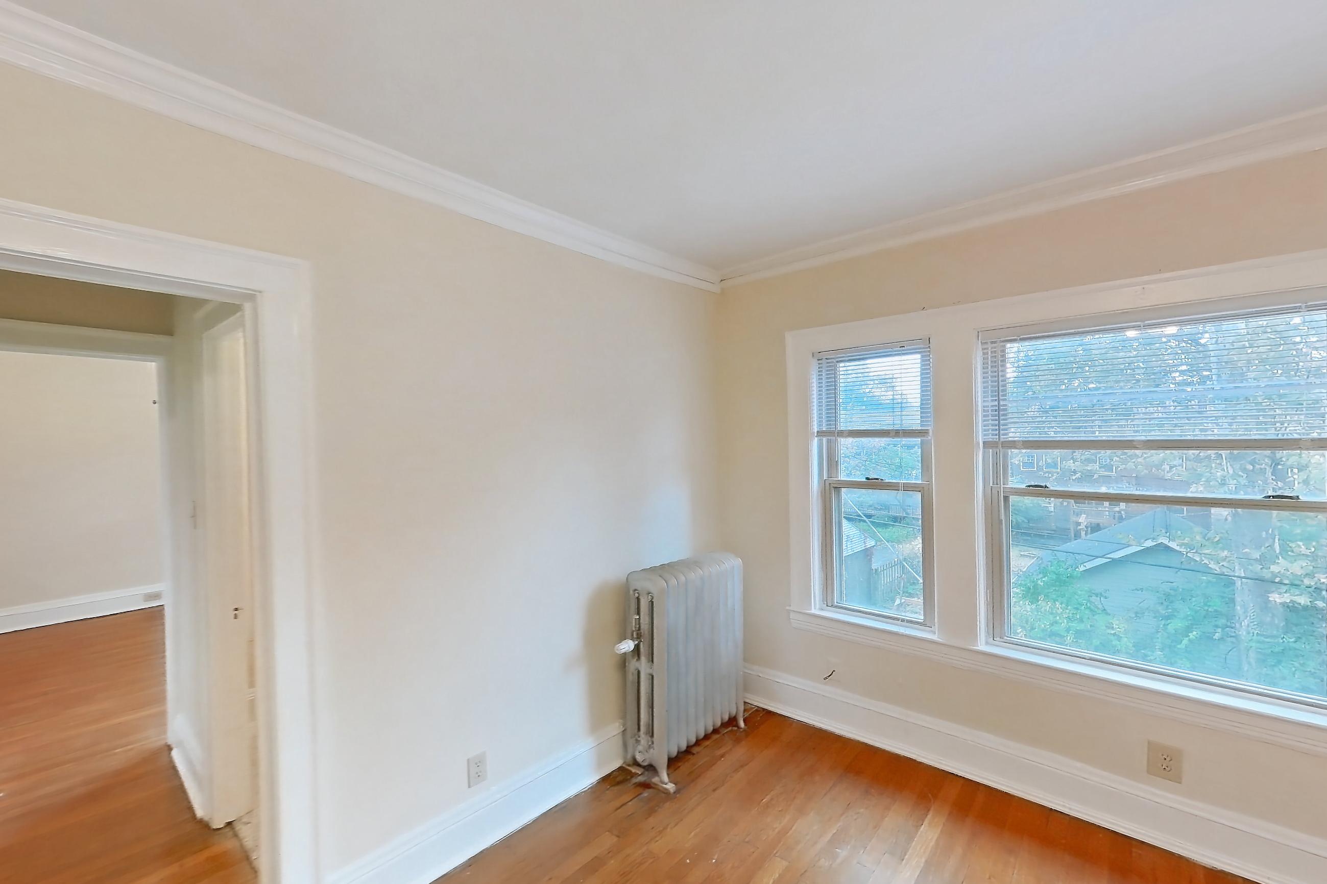 Living room with light wood-finish flooring, radiator heat, and wood-finish flooring, Apartment MVI-14 at Mapleview