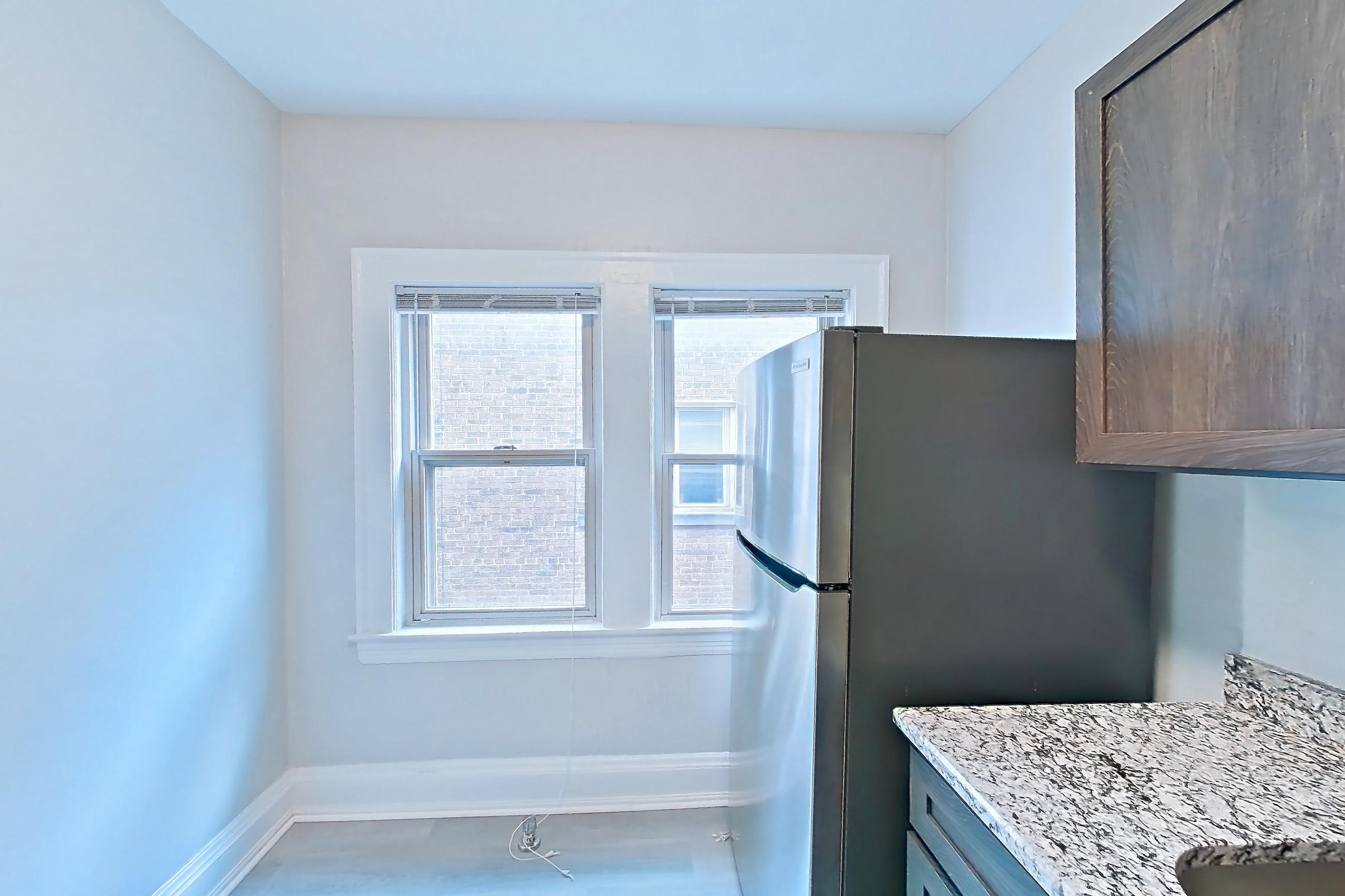 Kitchen with gas range, light stone countertops, light wood-finish flooring, oven/range, refrigerator, and stainless steel appliances, Apartment MVI-10 at Mapleview