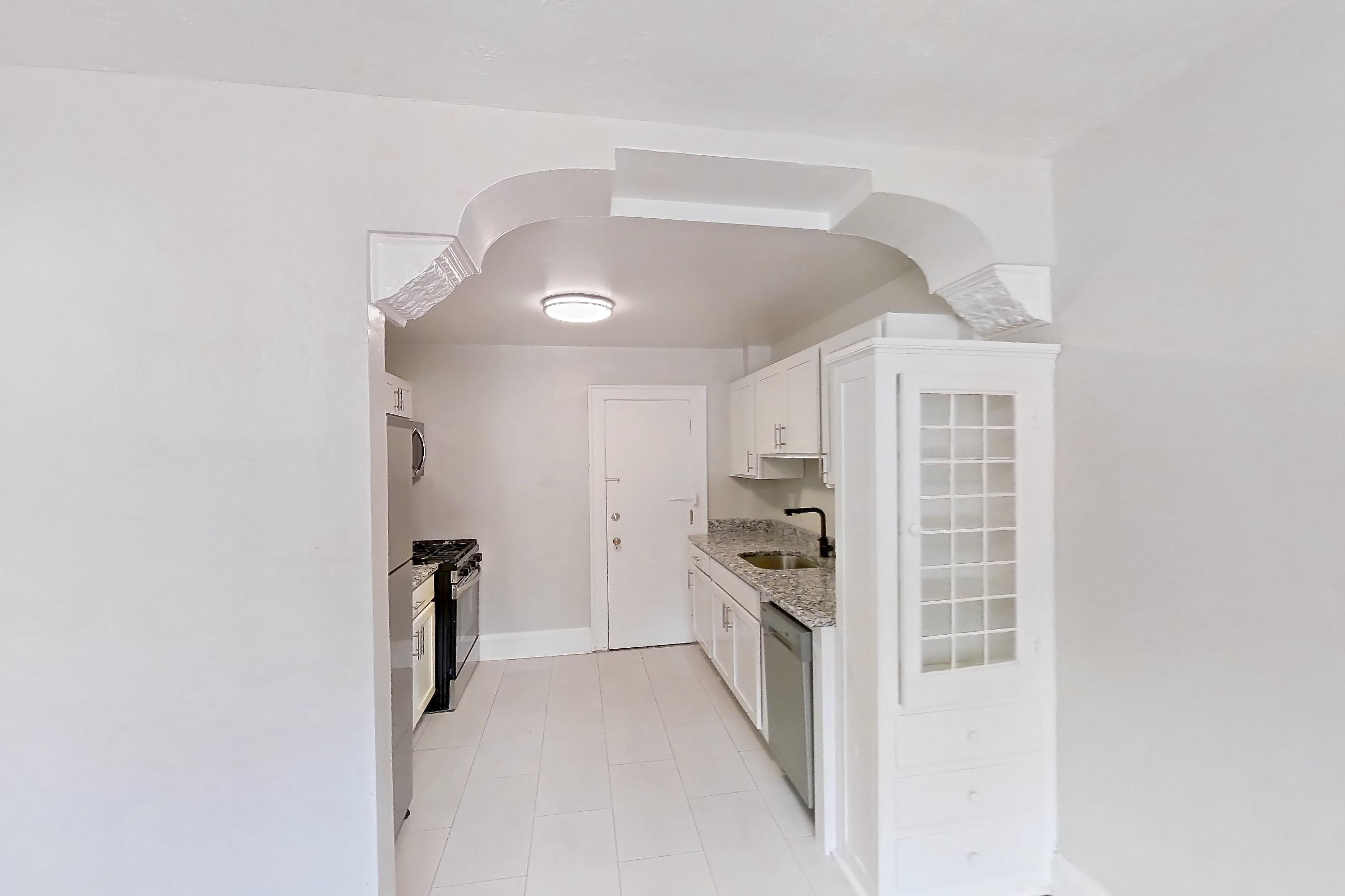 Dining room with dishwasher, light wood-finish flooring, stainless steel appliances, and wood-finish flooring, Apartment 89-108 at Lewis Manor
