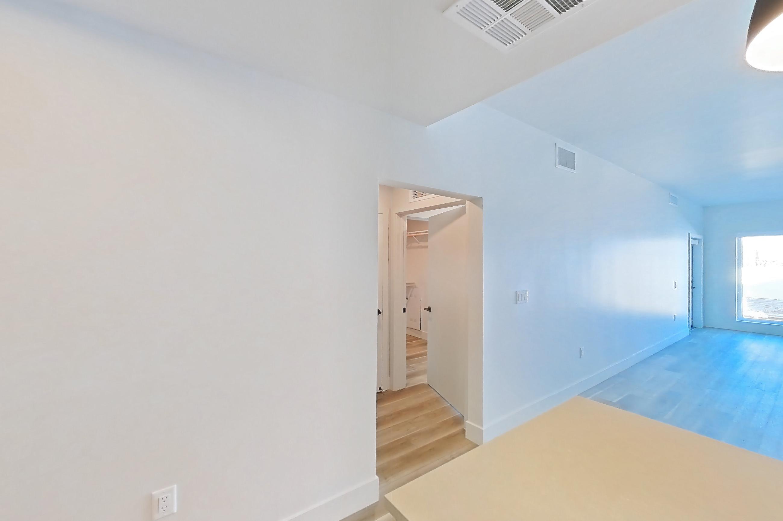 Kitchen with dishwasher, gas range, light countertops, light wood-finish flooring, microwave, oven/range, refrigerator, and stainless steel appliances, Apartment 339 at The Myles