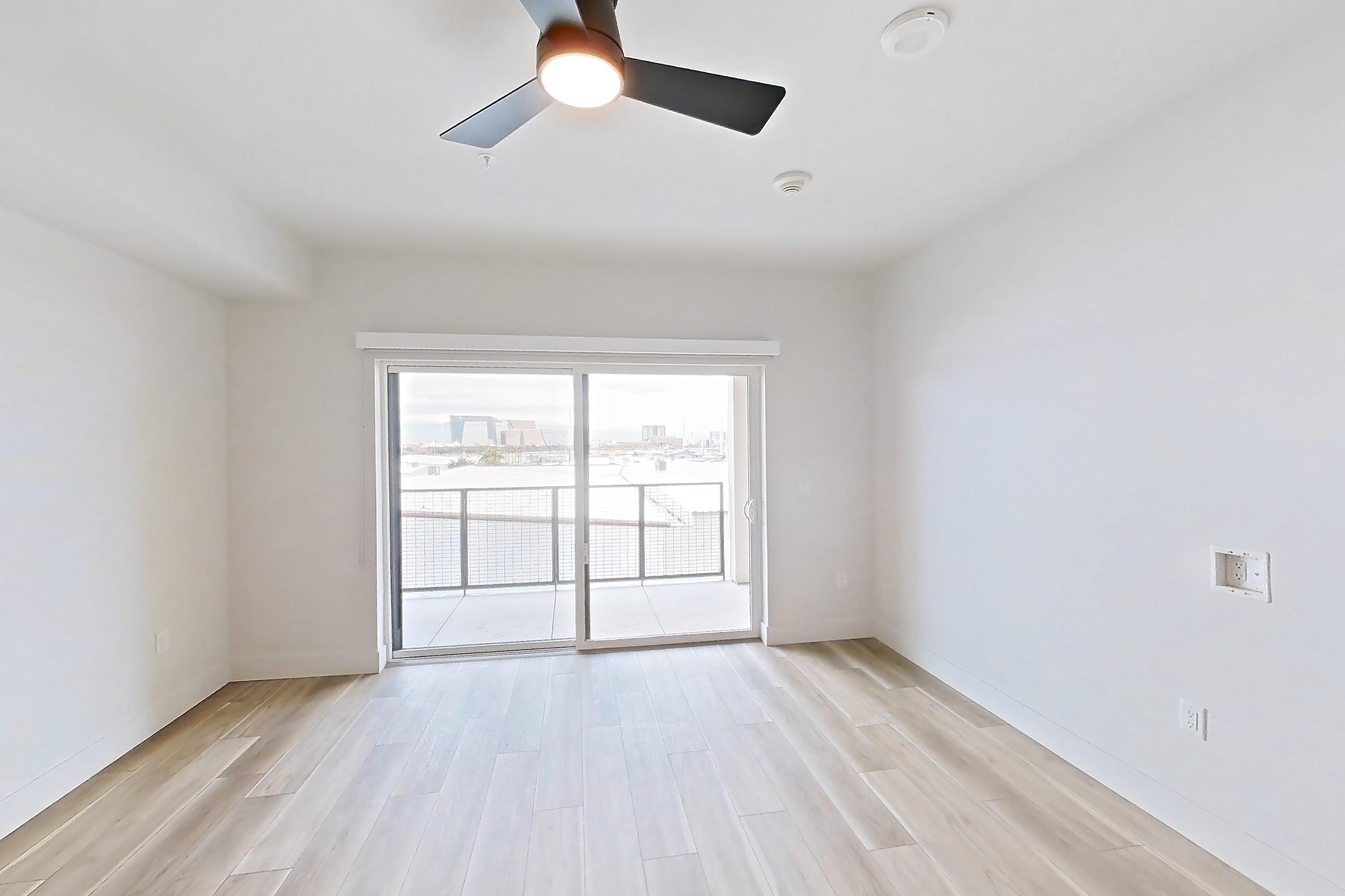 Living space with light wood-finish flooring, Apartment 435 at The Myles