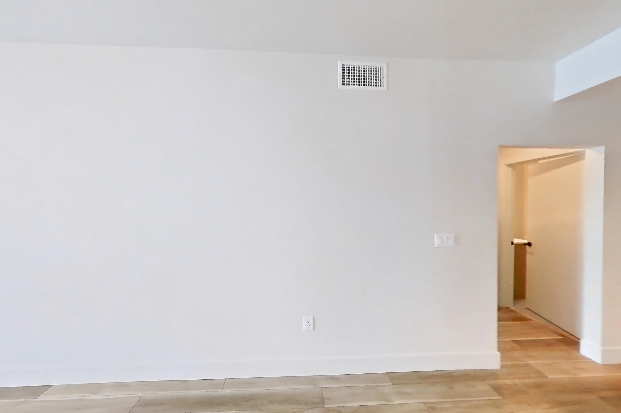 Living room with light wood-finish flooring, Apartment 437 at The Myles