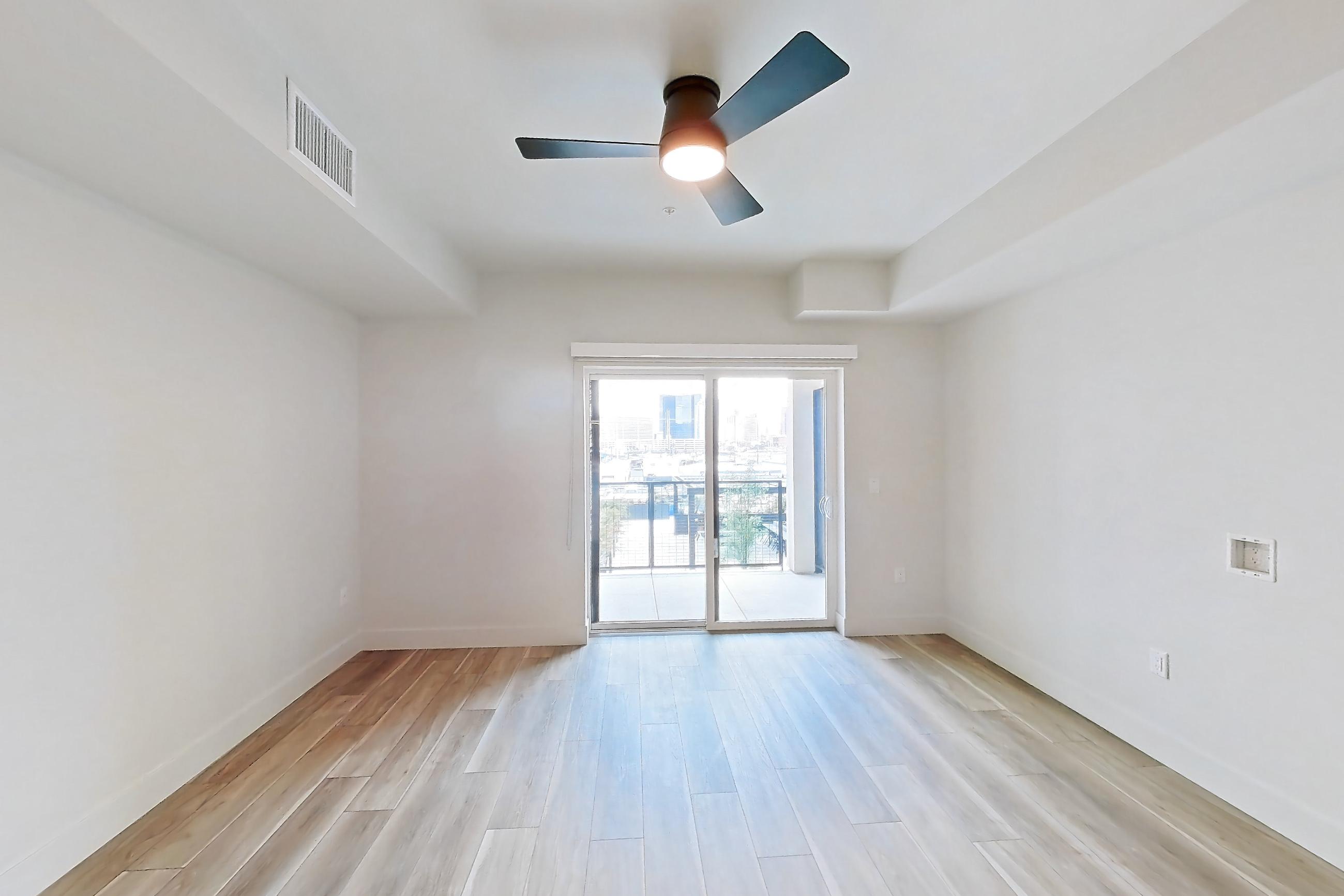 Living space with light wood-finish flooring, Apartment 438 at The Myles