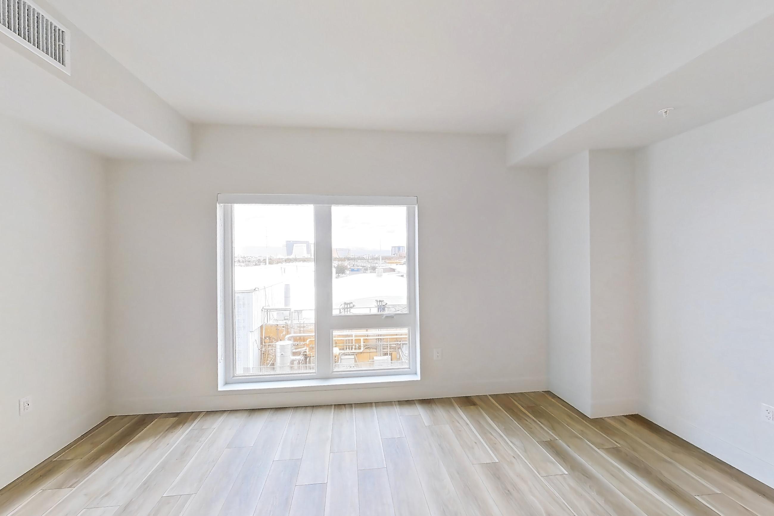 Living space with dishwasher, gas range, light countertops, light wood-finish flooring, oven/range, refrigerator, and stainless steel appliances, Apartment 443 at The Myles