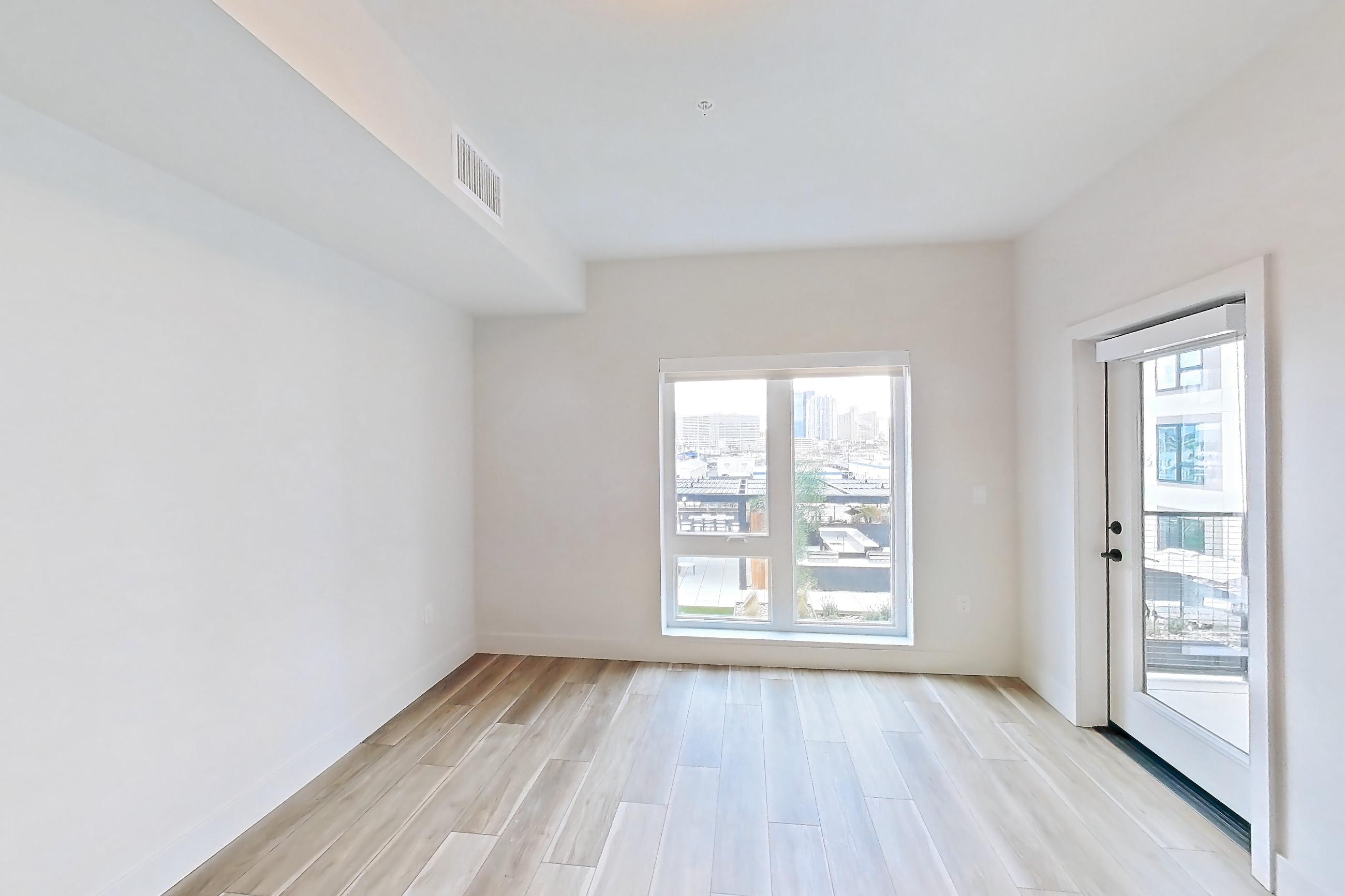 Living room with light wood-finish flooring and wood-look tile flooring, Apartment 442 at The Myles