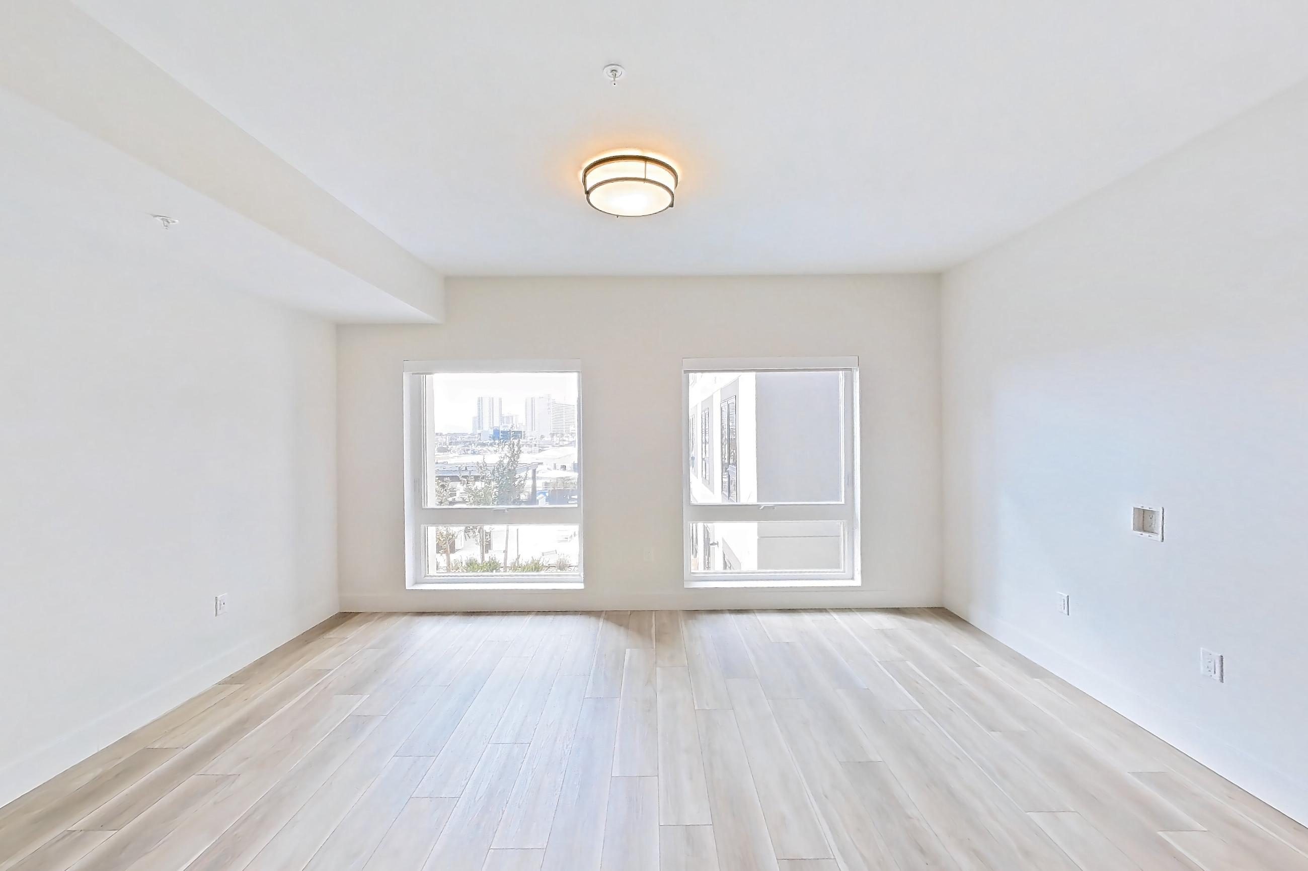 Living room with light wood-finish flooring and wood-look tile flooring, Apartment 446 at The Myles