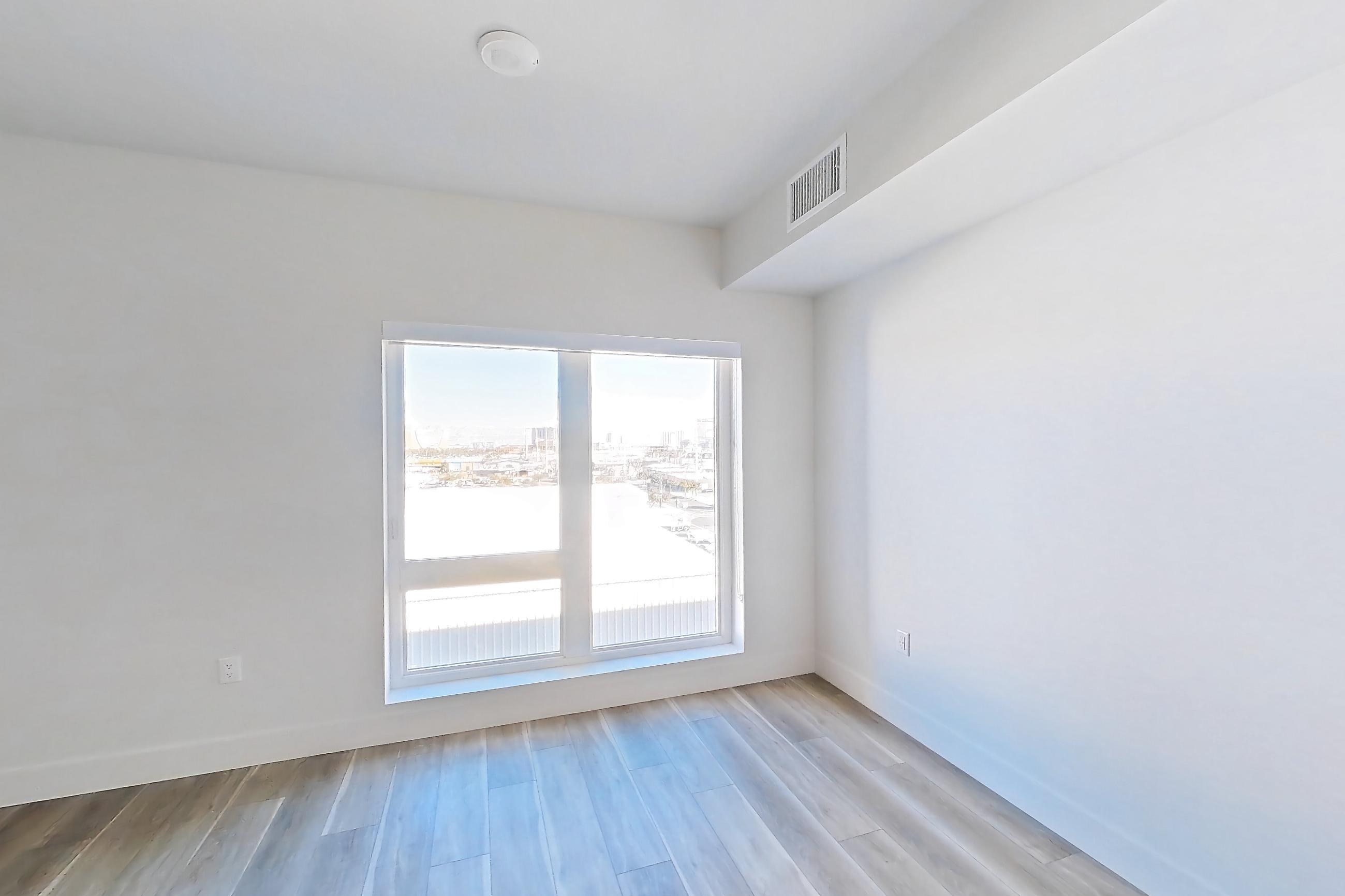 Living space with dishwasher, gas range, light countertops, light wood-finish flooring, oven/range, stainless steel appliances, and wood-look tile flooring, Apartment 518 at The Myles