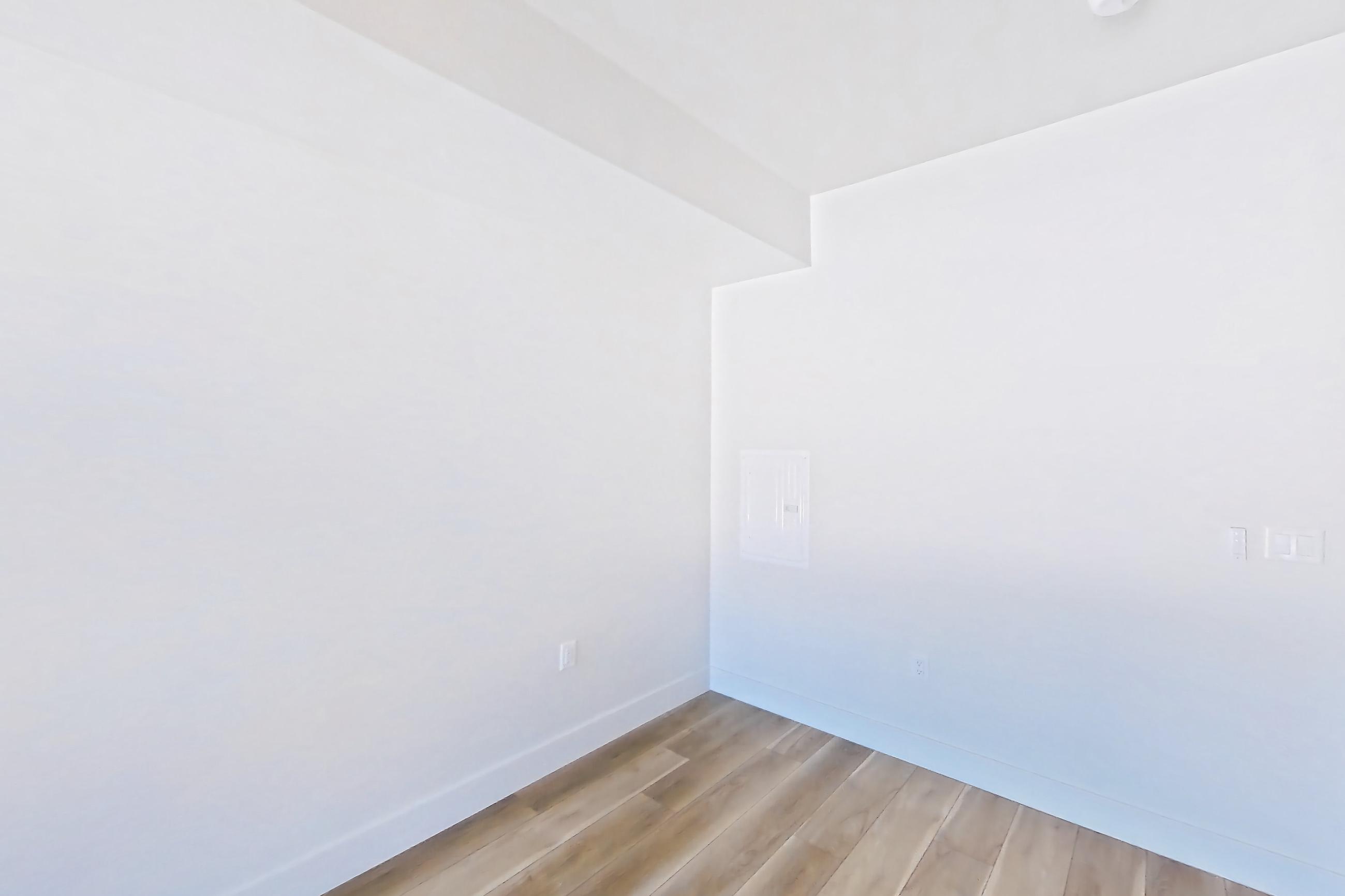 Living space with dishwasher, gas range, light countertops, light wood-finish flooring, oven/range, stainless steel appliances, and wood-look tile flooring, Apartment 518 at The Myles