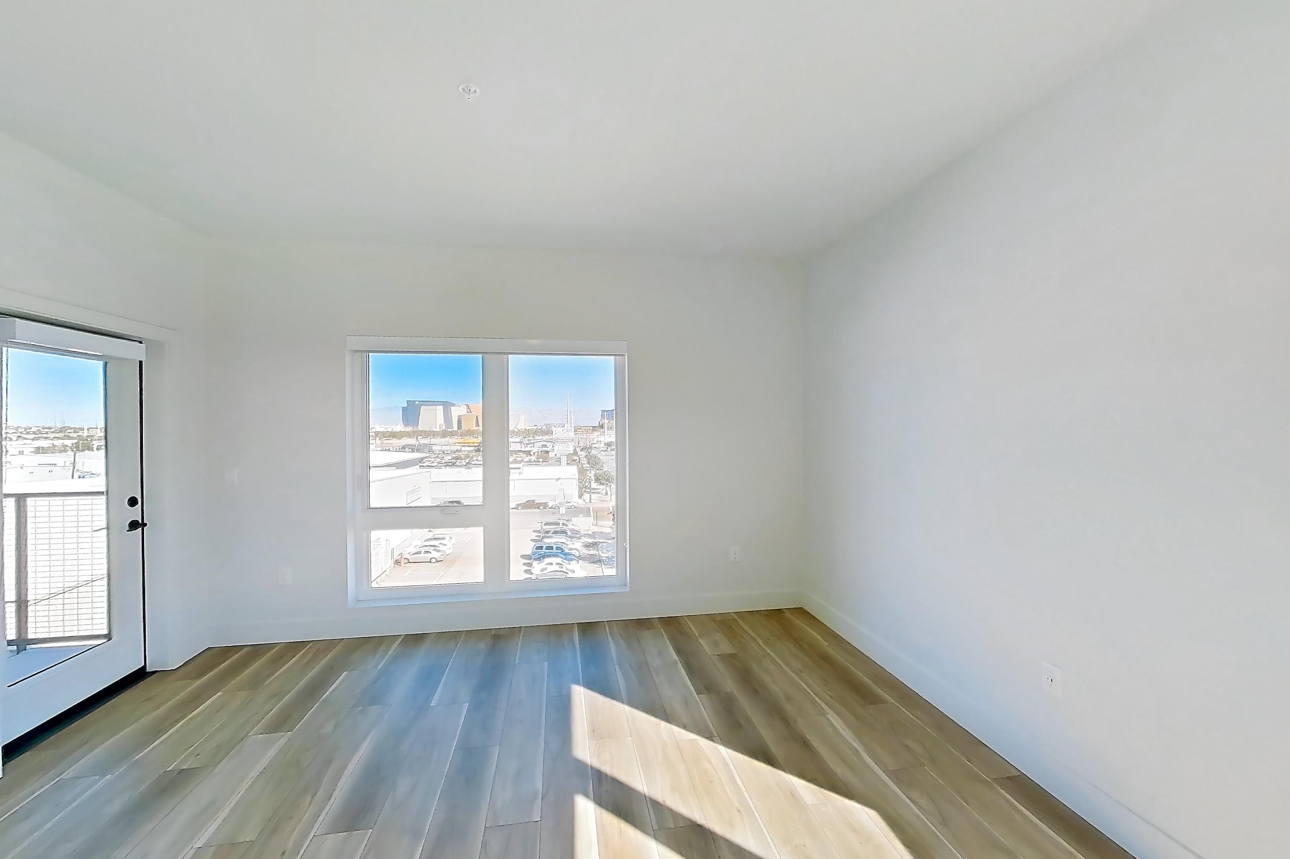 Living room with wood-look tile flooring, Apartment 524 at The Myles