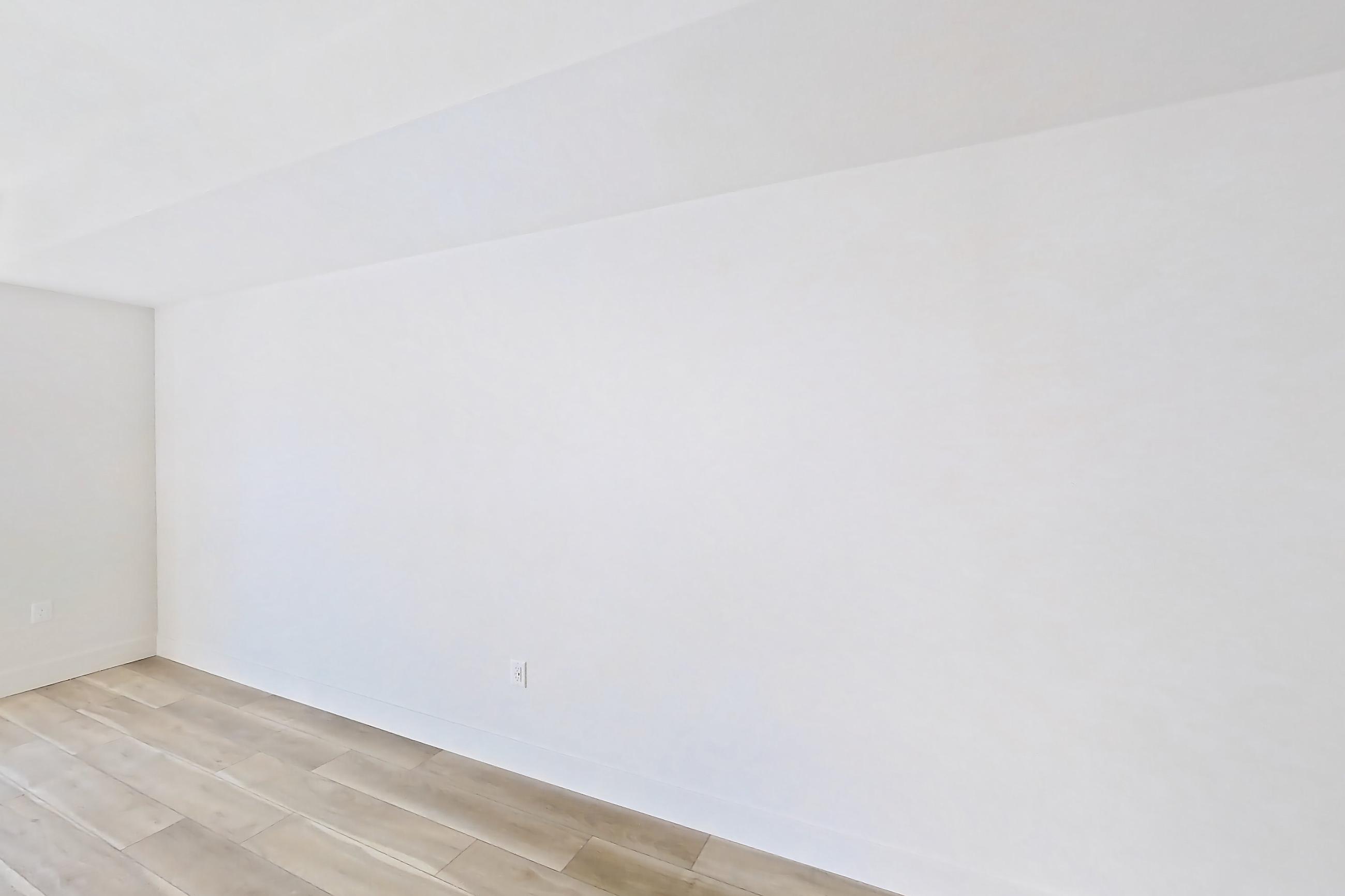 Living room with light wood-finish flooring, Apartment 525 at The Myles
