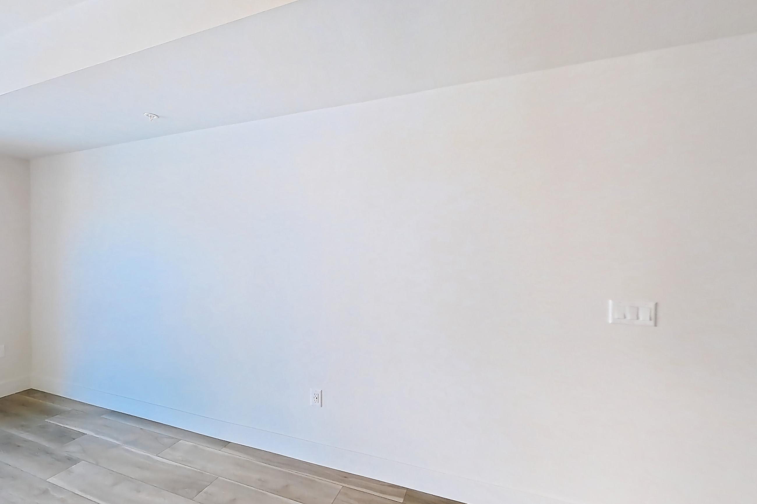 Living room with light wood-finish flooring, Apartment 527 at The Myles